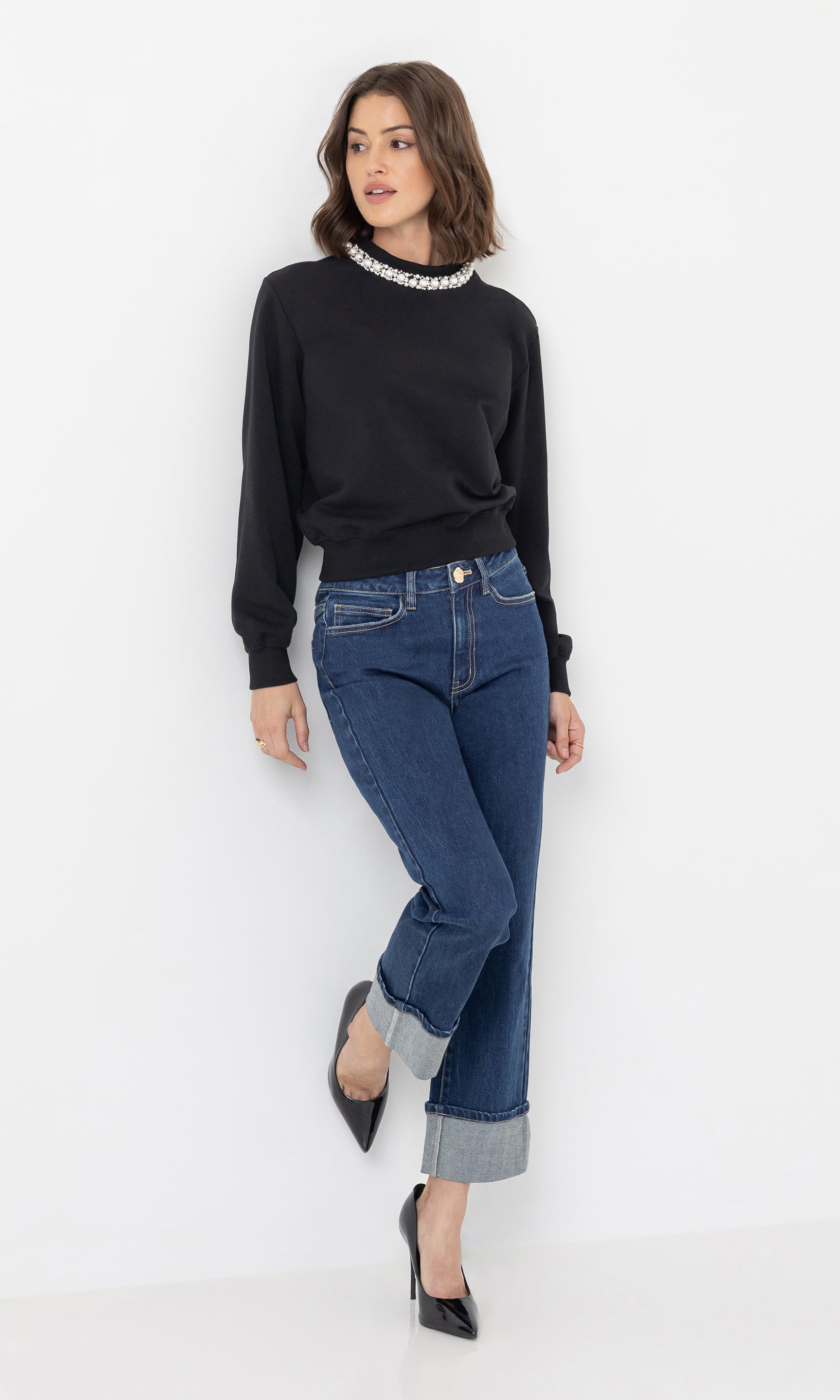 Full body front view of the model in the ryland denim jeans styled with heels.