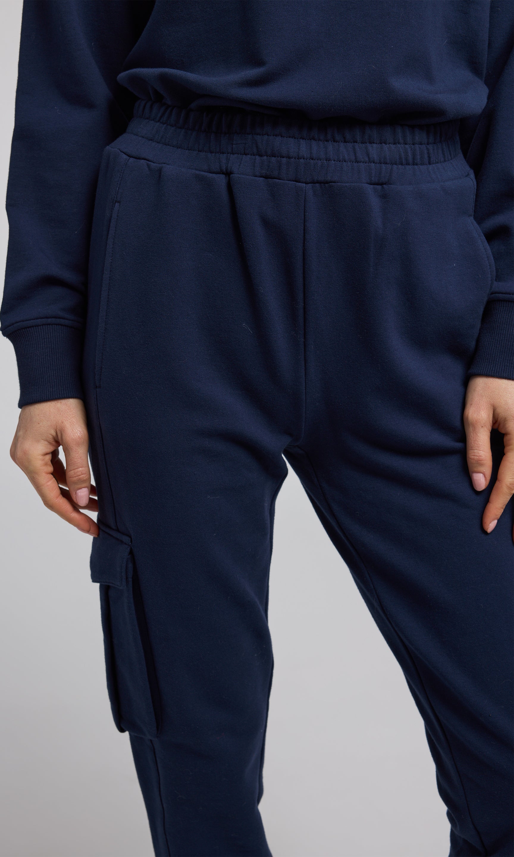 Navy sweatpants crafted from soft, stretchy material, offering comfort and flexibility for everyday wear.
