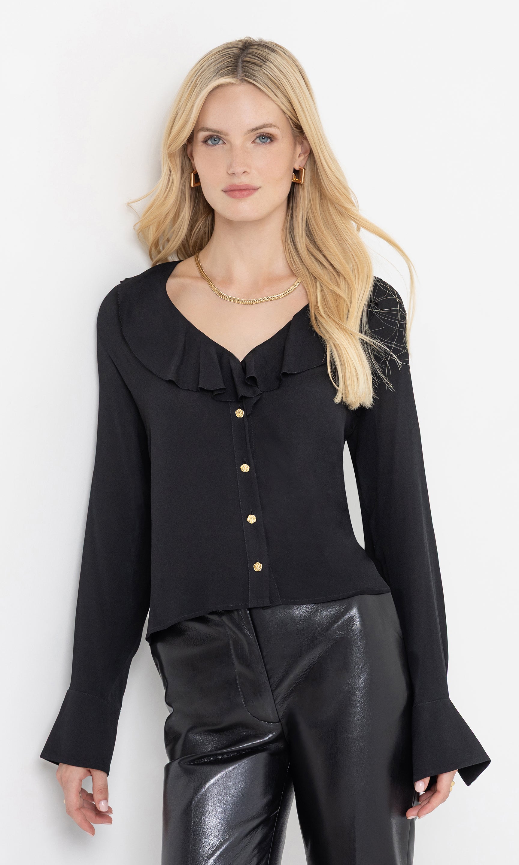 Front view of the model wearing the kassy blouse with ruffle neckline.