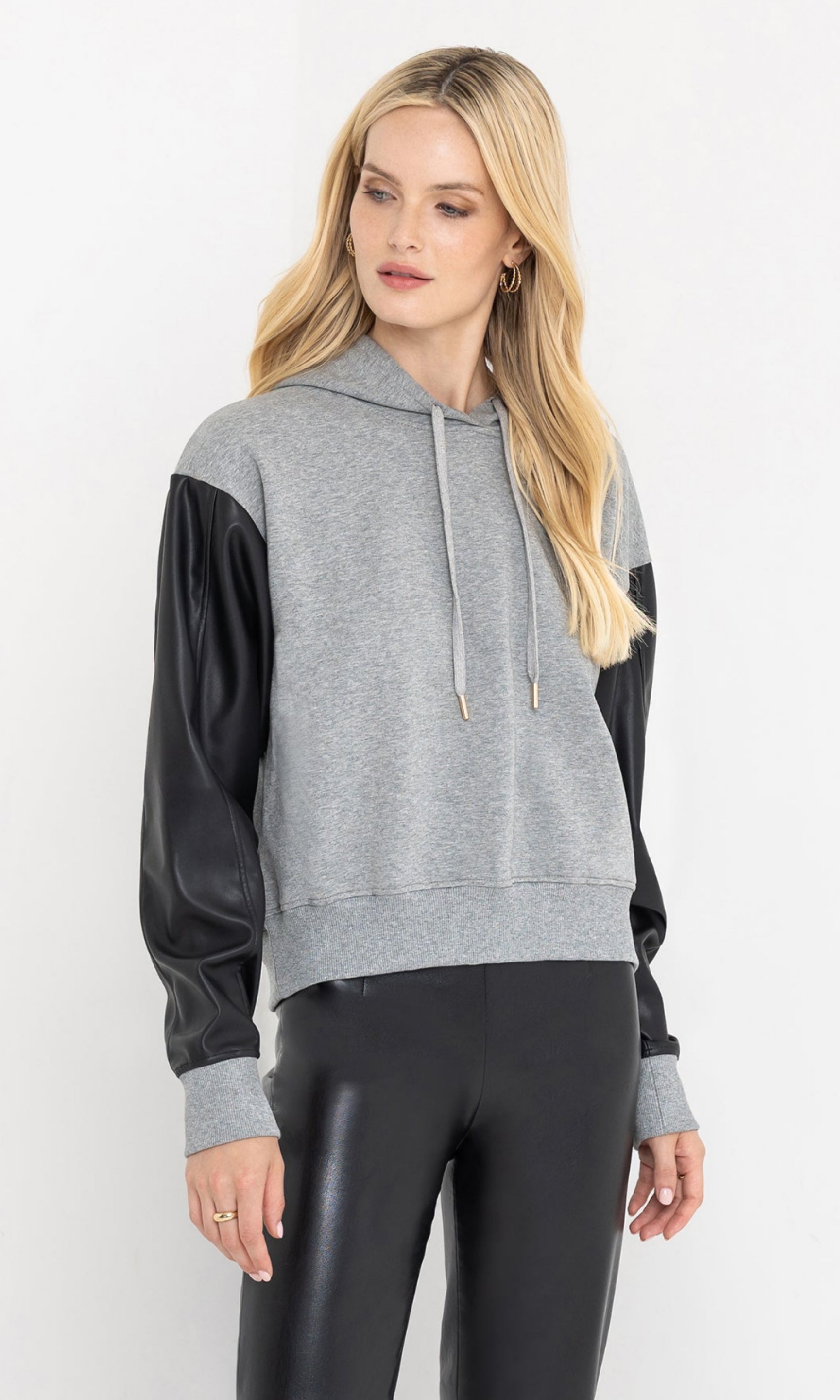 Side view of the lisbet vegan leather combo hoodie highlighting the sleeves.