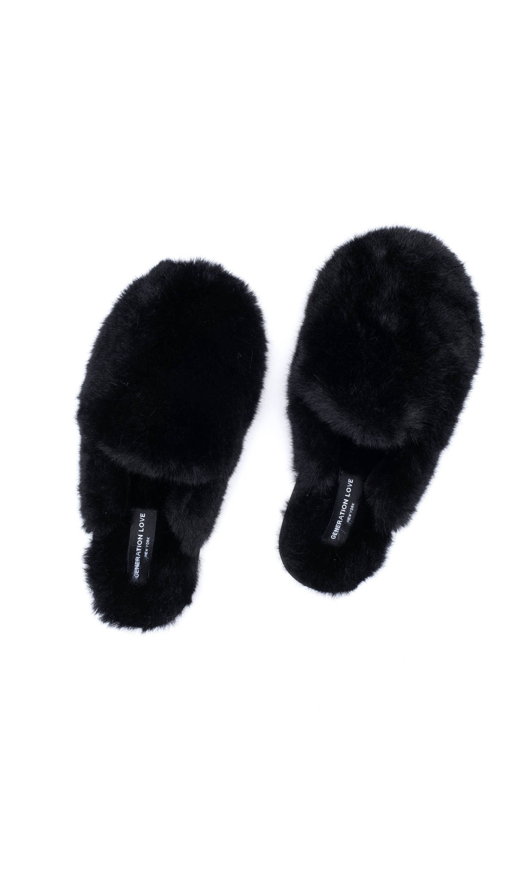 Pair of black fluffy slippers on a white background