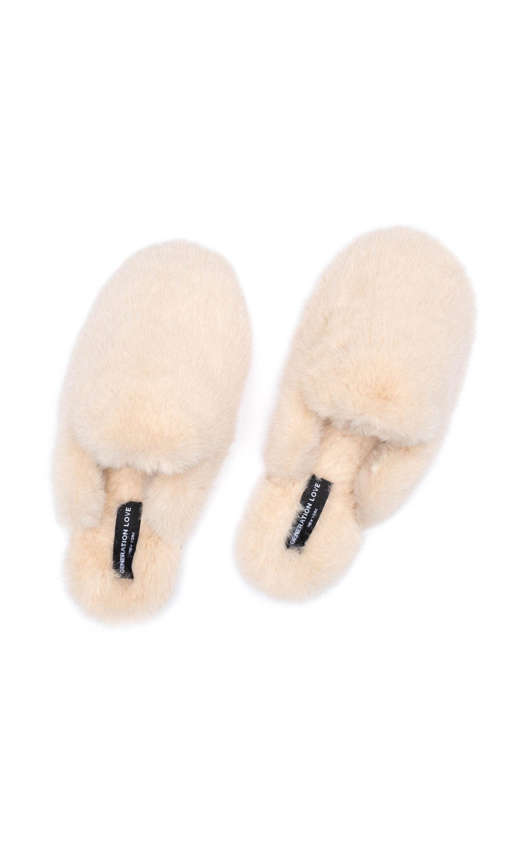 Pair of beige fluffy slippers on a white background