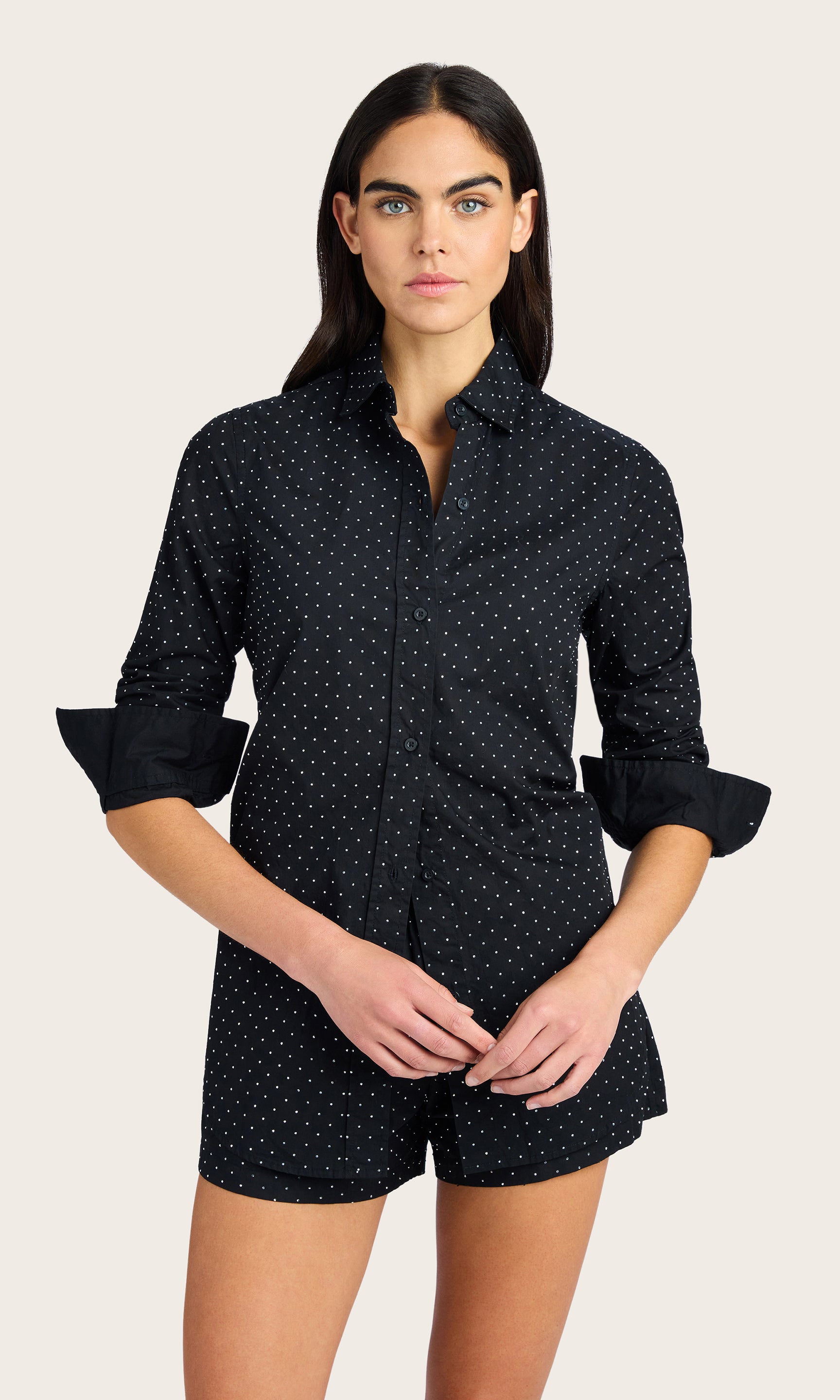Front view of the model wearing the Marc Crystal Shirt styled with shorts having rolled sleeves.