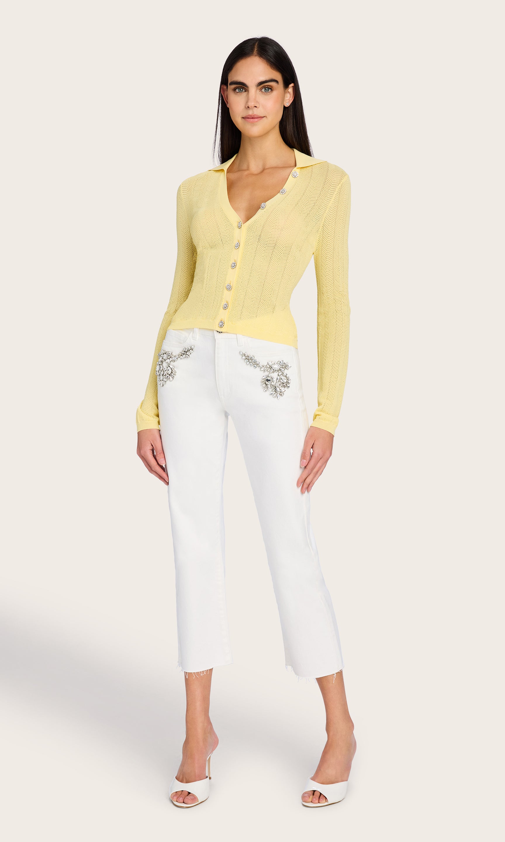 Full-body front view of the model in the Megan Pointelle Cardigan, creating a polished look with crisp white trousers.