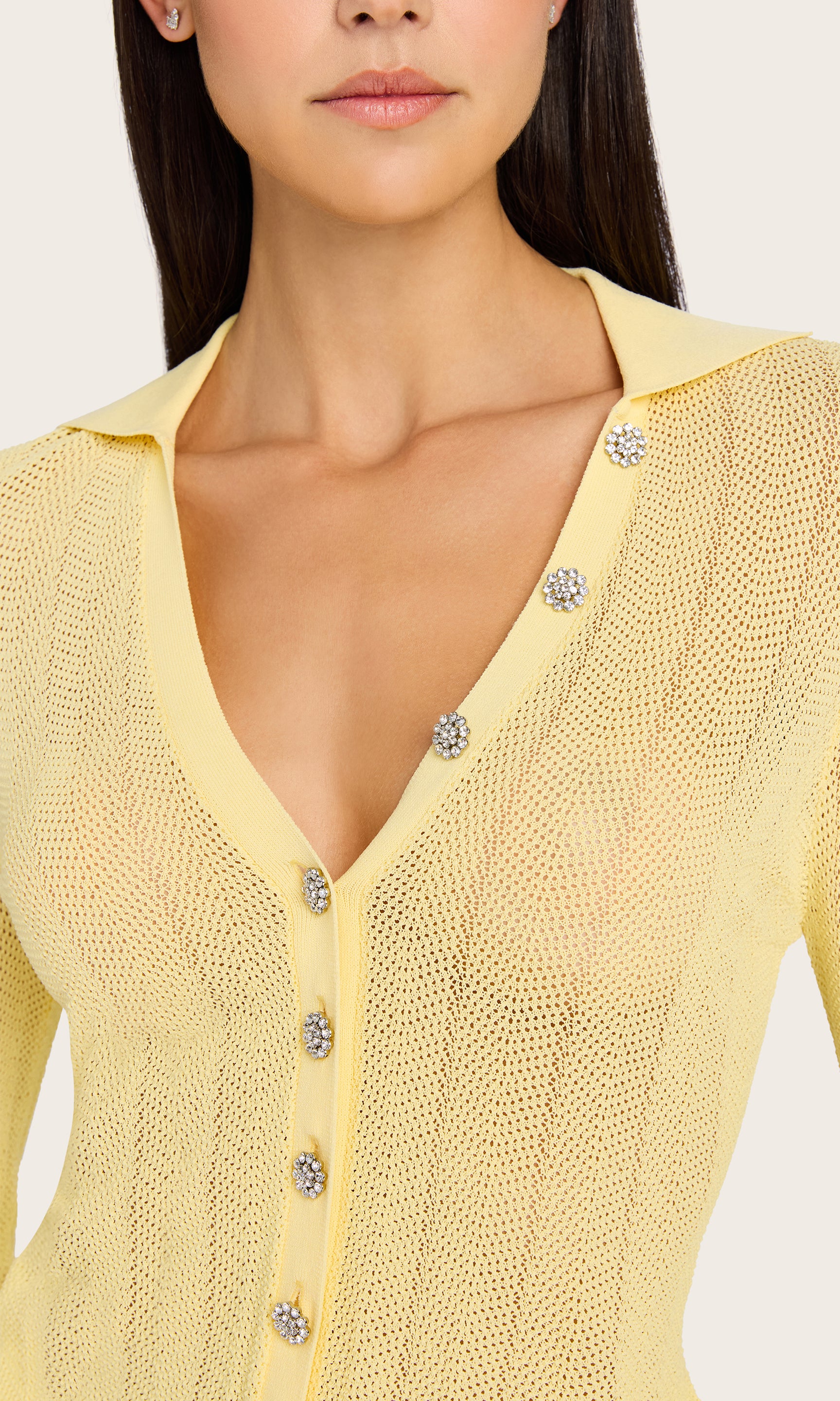 Close-up front view of the model in the Megan Pointelle Cardigan, showcasing the pointelle knit texture and V-neckline with button details.