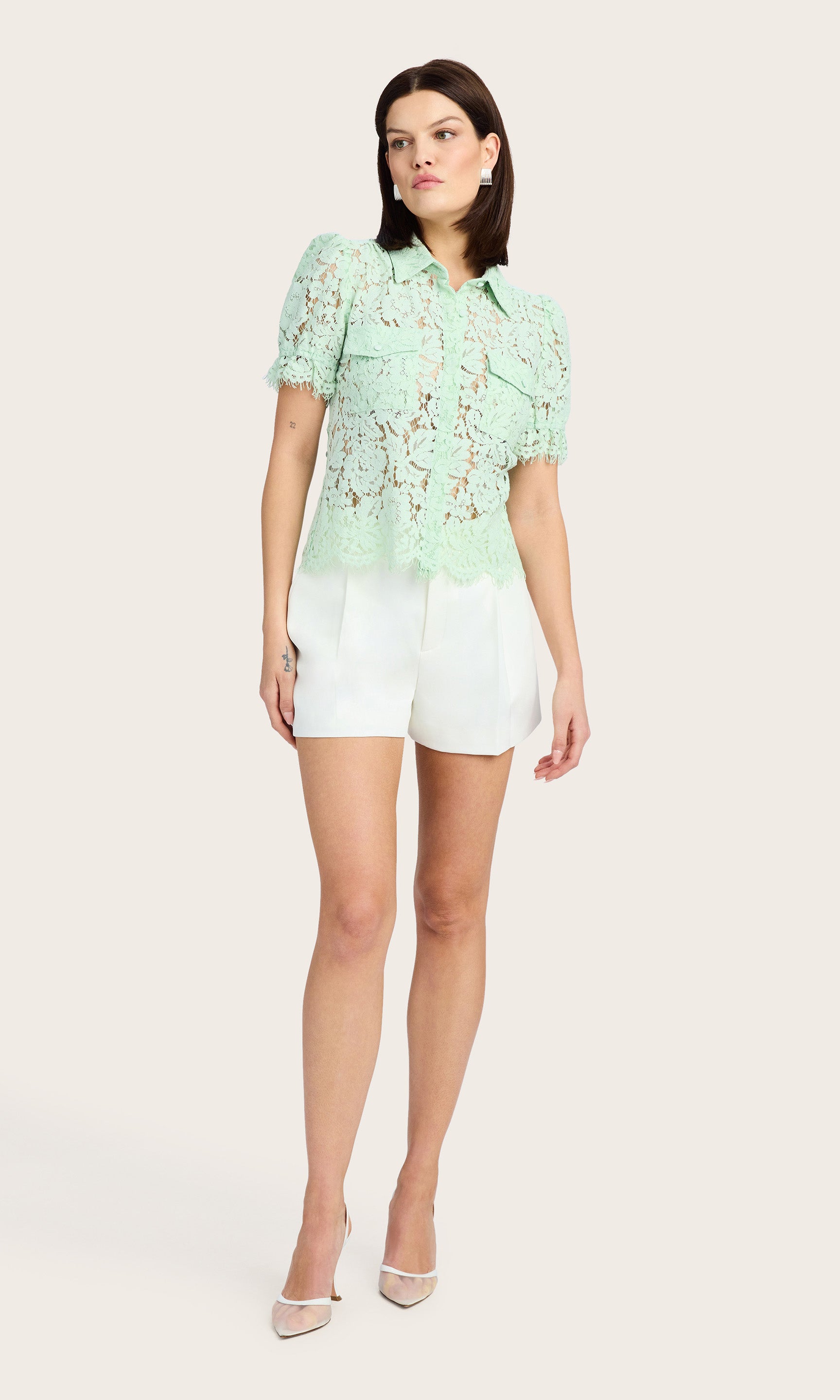 Full body view showcasing the lace detailing and chest flap pockets of the mint green blouse