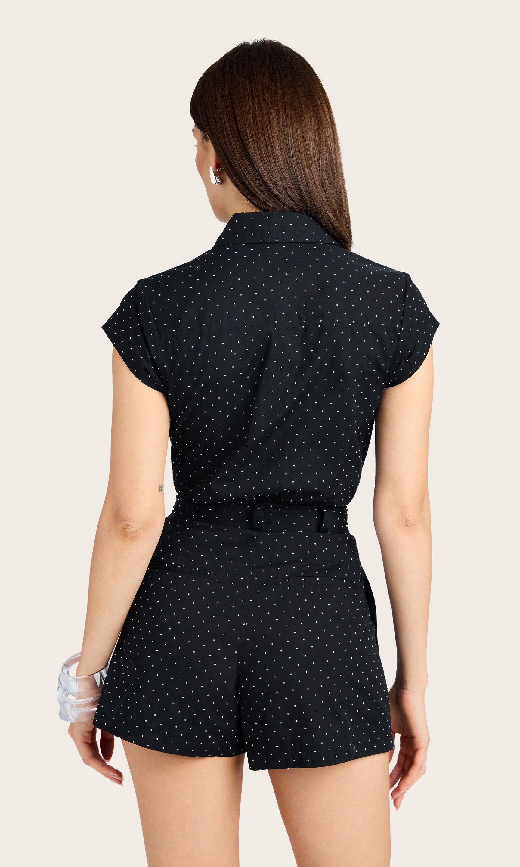 Rear view of the romper showing the back welt pockets and relaxed fit.
