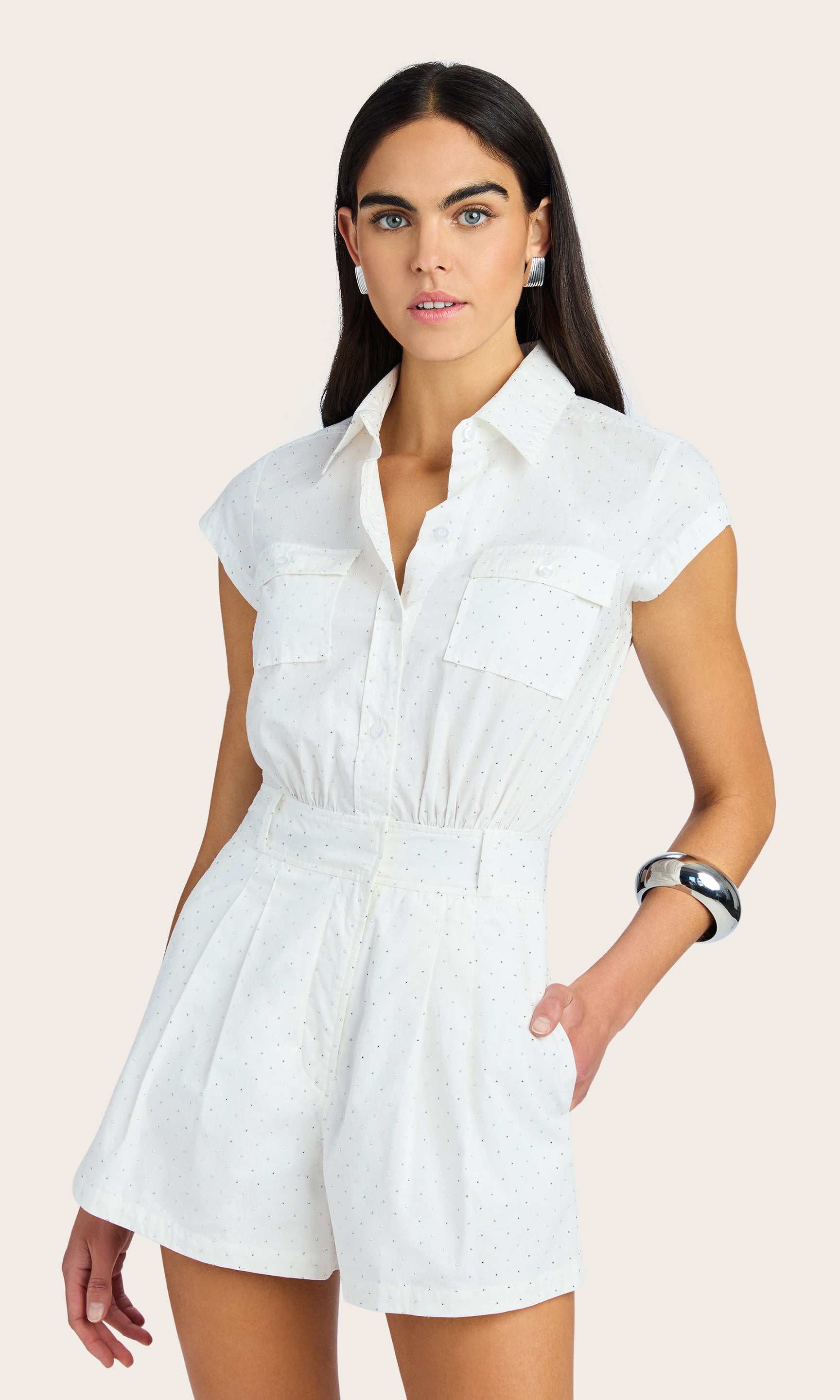 Front view of the model posing with one leg bent, showcasing the flattering silhouette and short sleeves of the Morgan Crystal Poplin Romper.