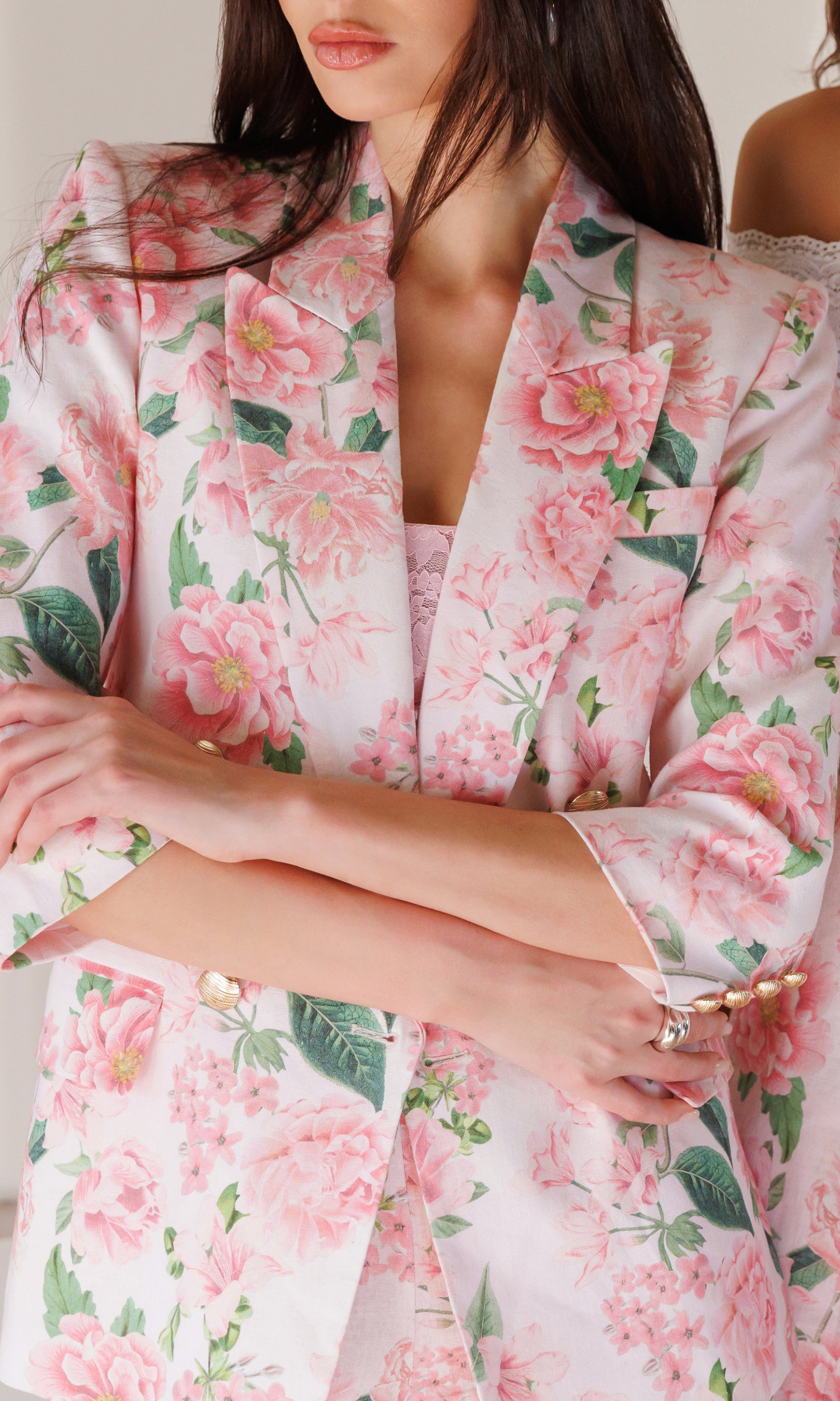 Close-up of a floral blazer with pink flowers and green leaves