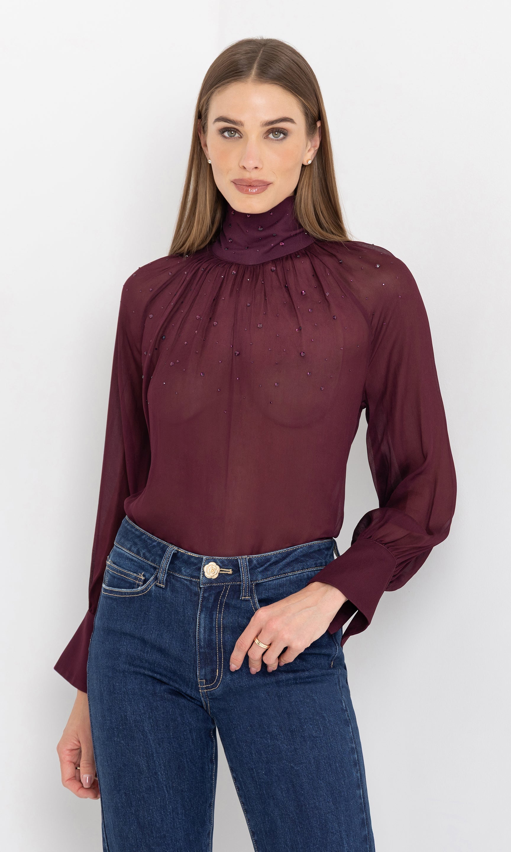 Front view of the noor crystal blouse paired with jeans.