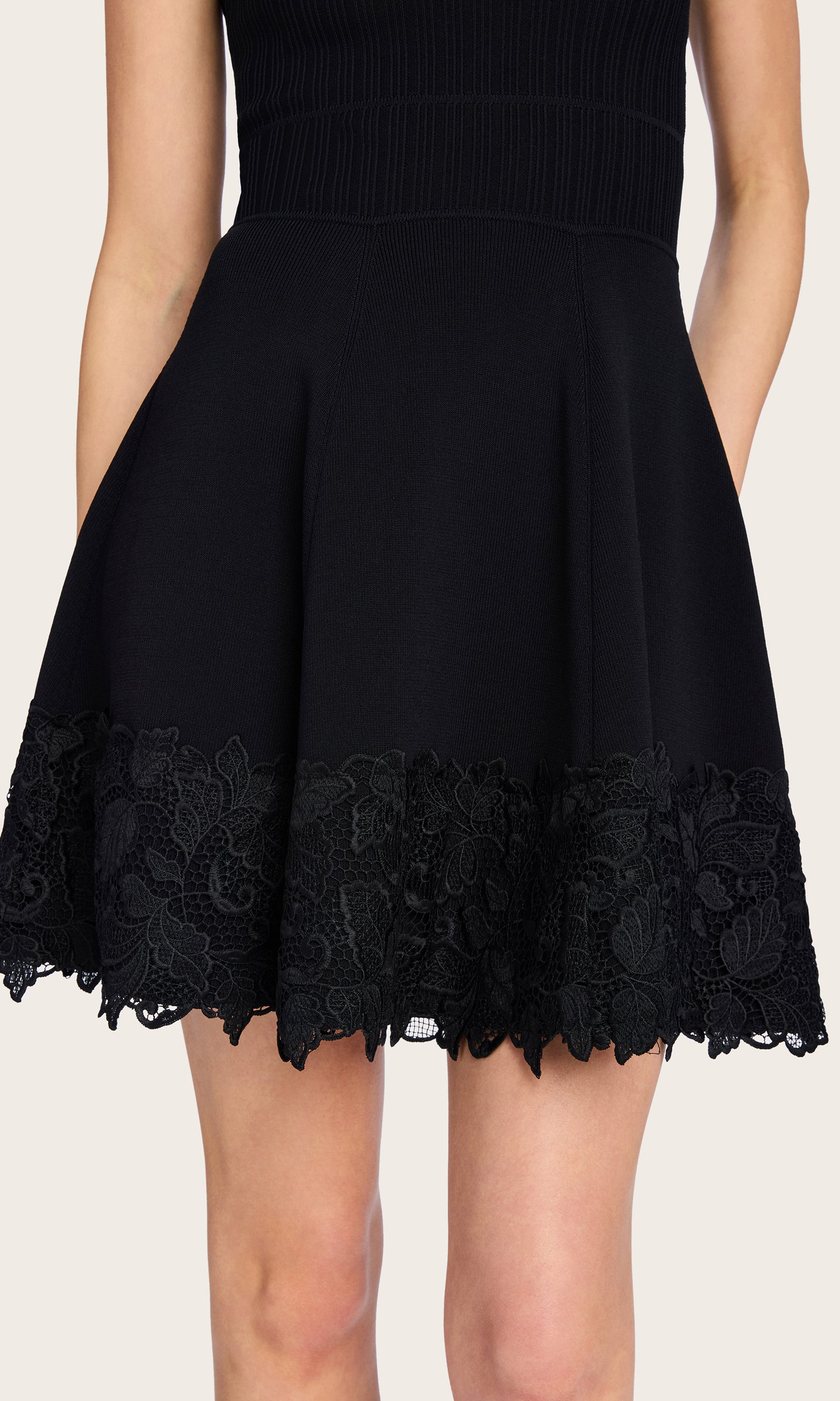 Close-up of the Orpheus Lace Combo Rib Dress on the model, emphasizing the ribbed texture and floral lace detailing at the hem.