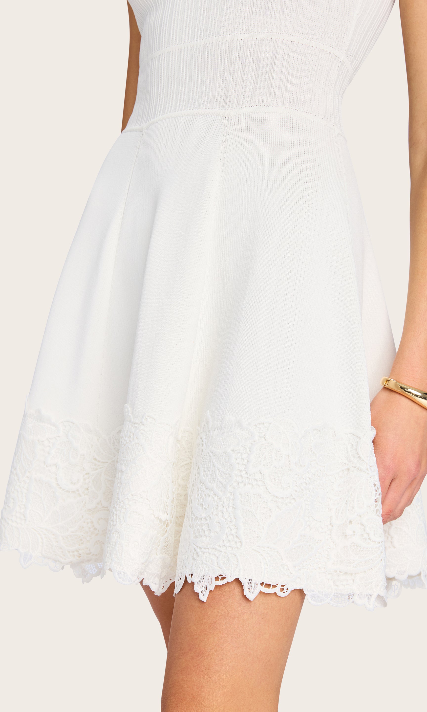 Close-up of the white Orpheus Lace Combo Rib Dress on the model, highlighting the ribbed texture and scalloped lace detailing.