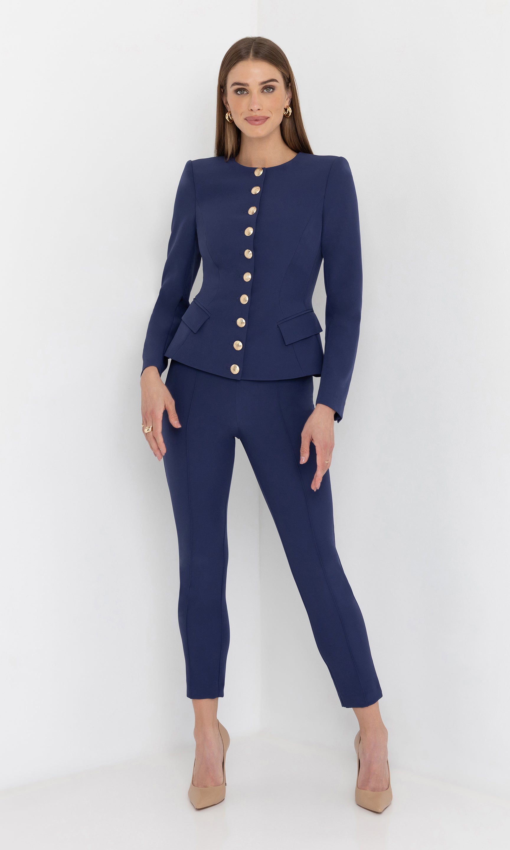 Full body front view of the model in the ophelia crepe jacket paired with slim trousers and heels.