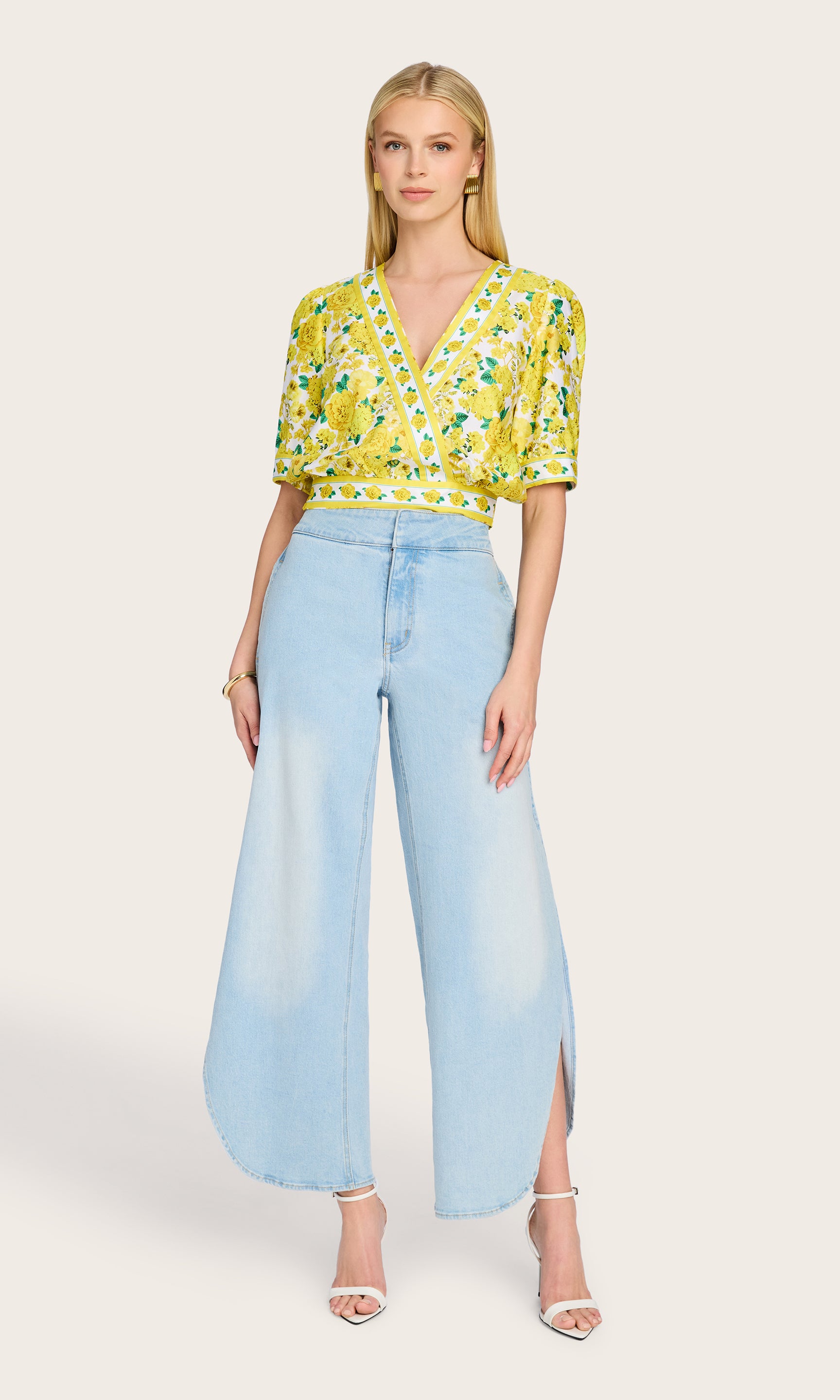 Full-body front view of the model wearing the Rema Floral Poplin Blouse with wide-leg denim, creating a bright and breezy summer look.