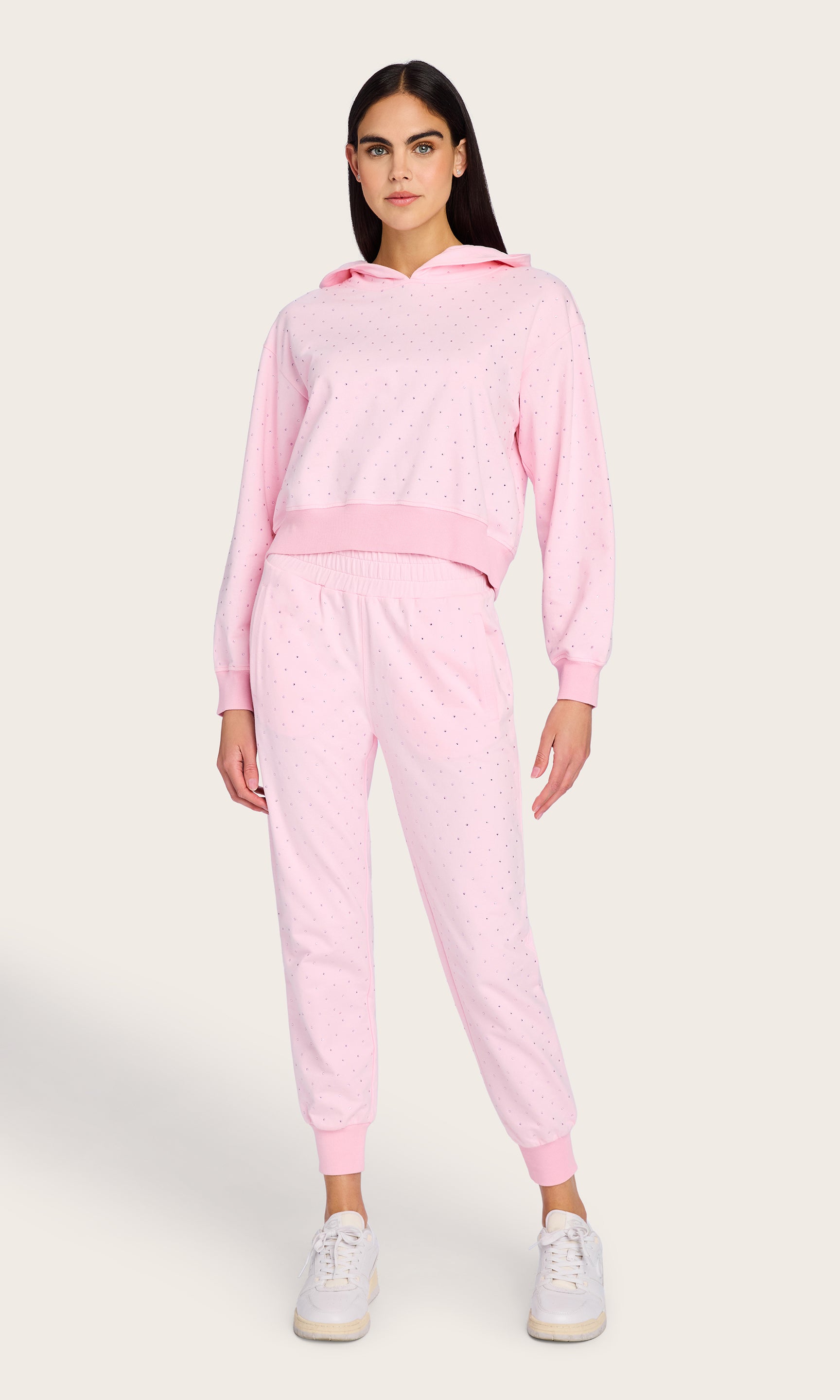 Full body view of the model in the Ruel Crystal Sweatpants and sweatshirt set, paired with white sneakers for a polished lounge look
