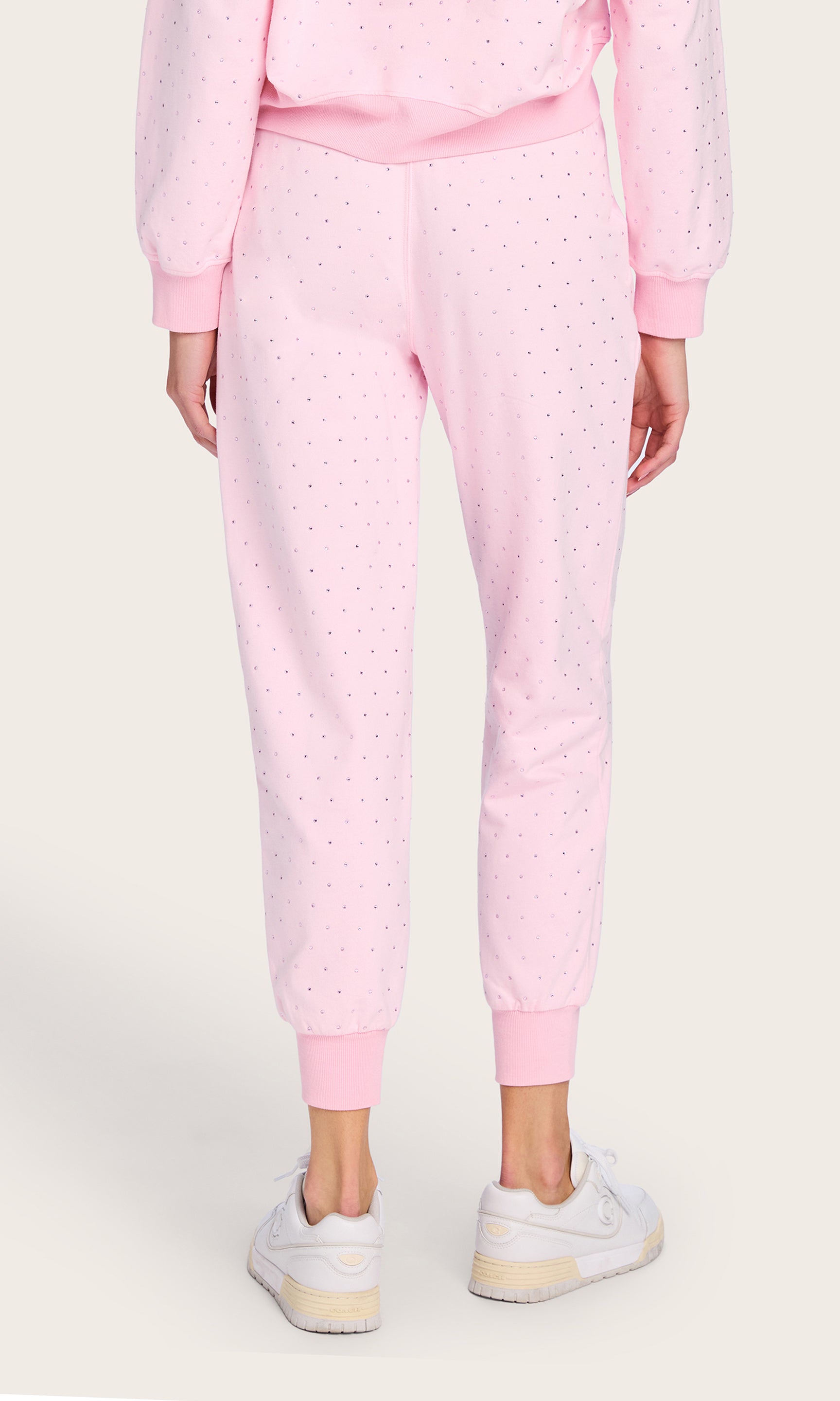 Rear view capturing the back fit and gathered hem of the Ruel Crystal Sweatpants, offering a laid-back and flattering profile