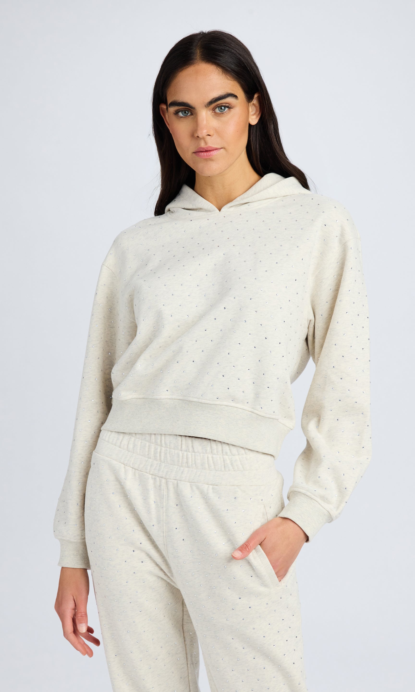 Model stands wearing a heather grey crystal sweatshirt
