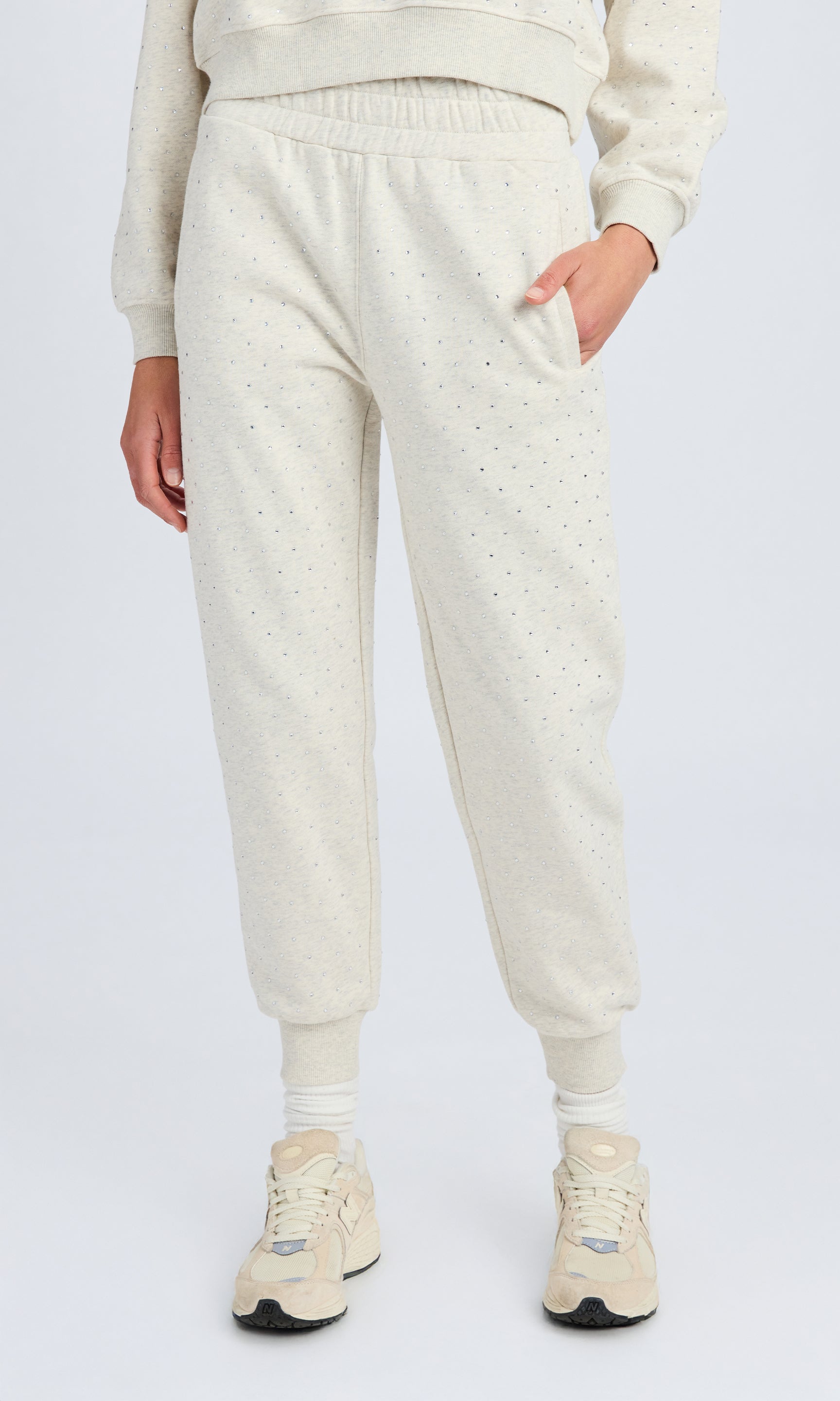 Front view of light grey sweatpants with crystals all over
