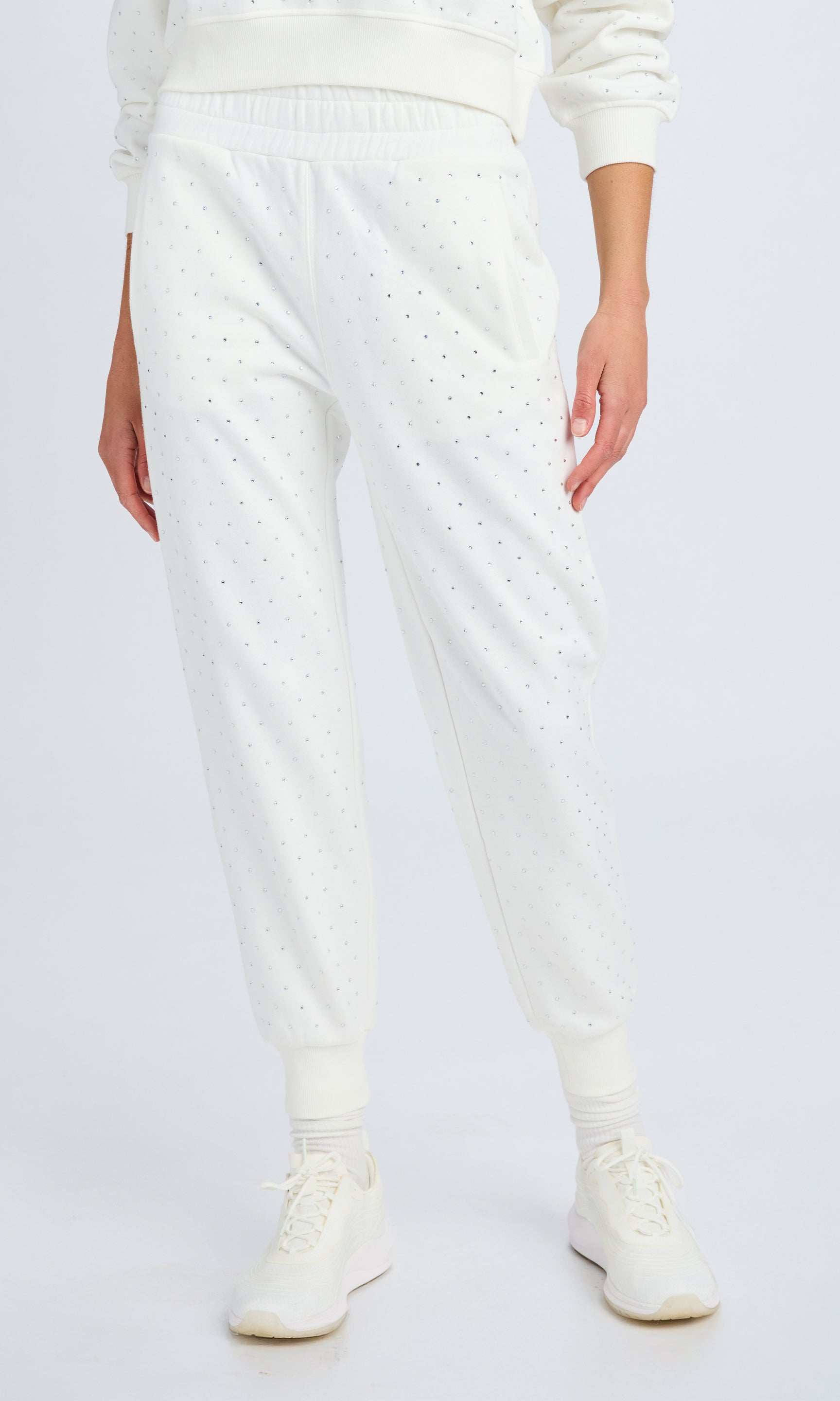 front view of white fleece sweatpants with clear crystal embellishments