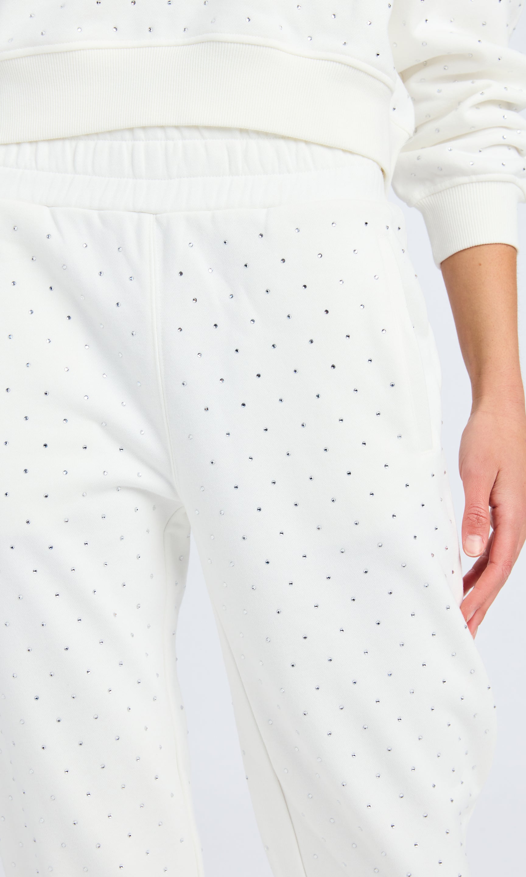 Close up of white sweatpants with clear crystals