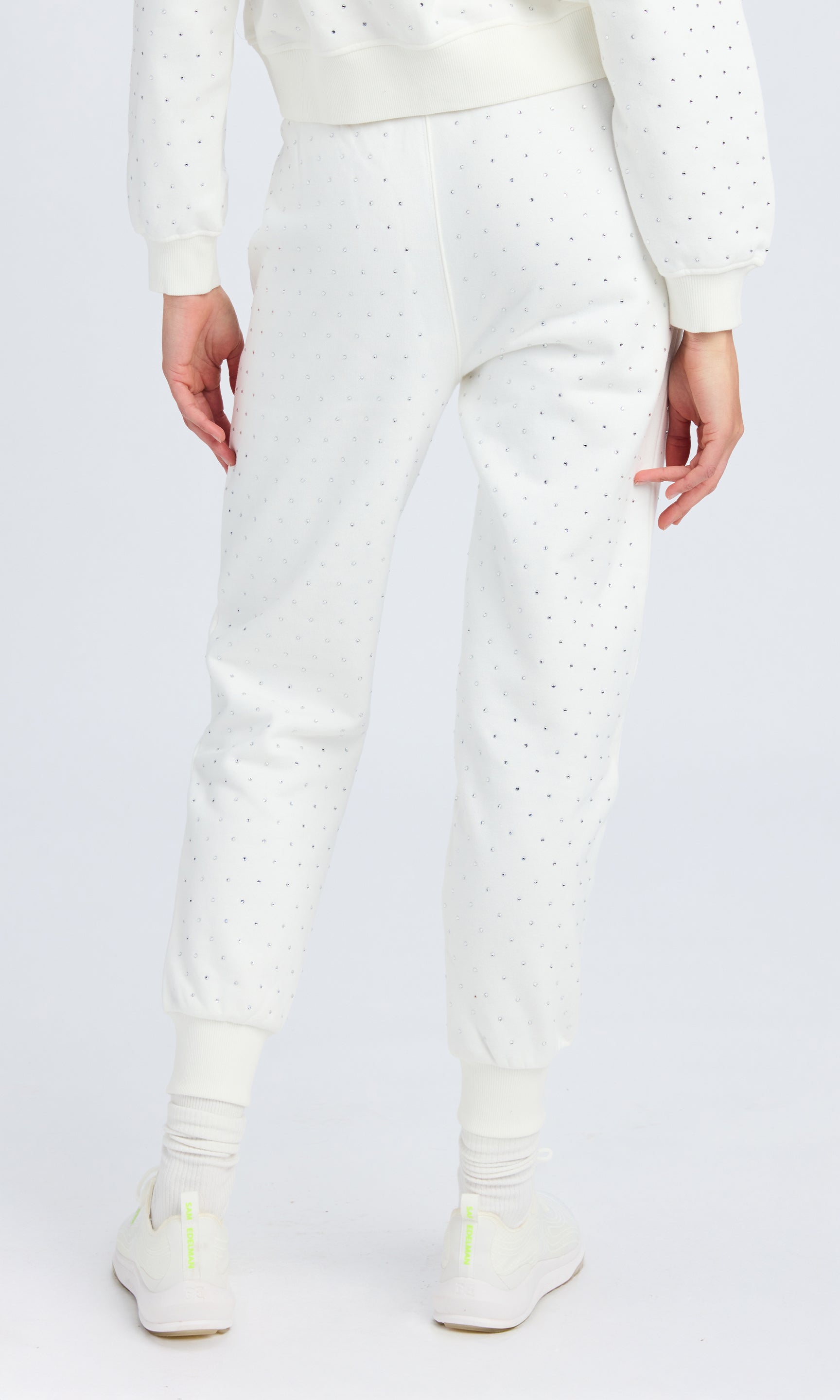 rear view of white fleece sweatpants with clear crystal embellishments