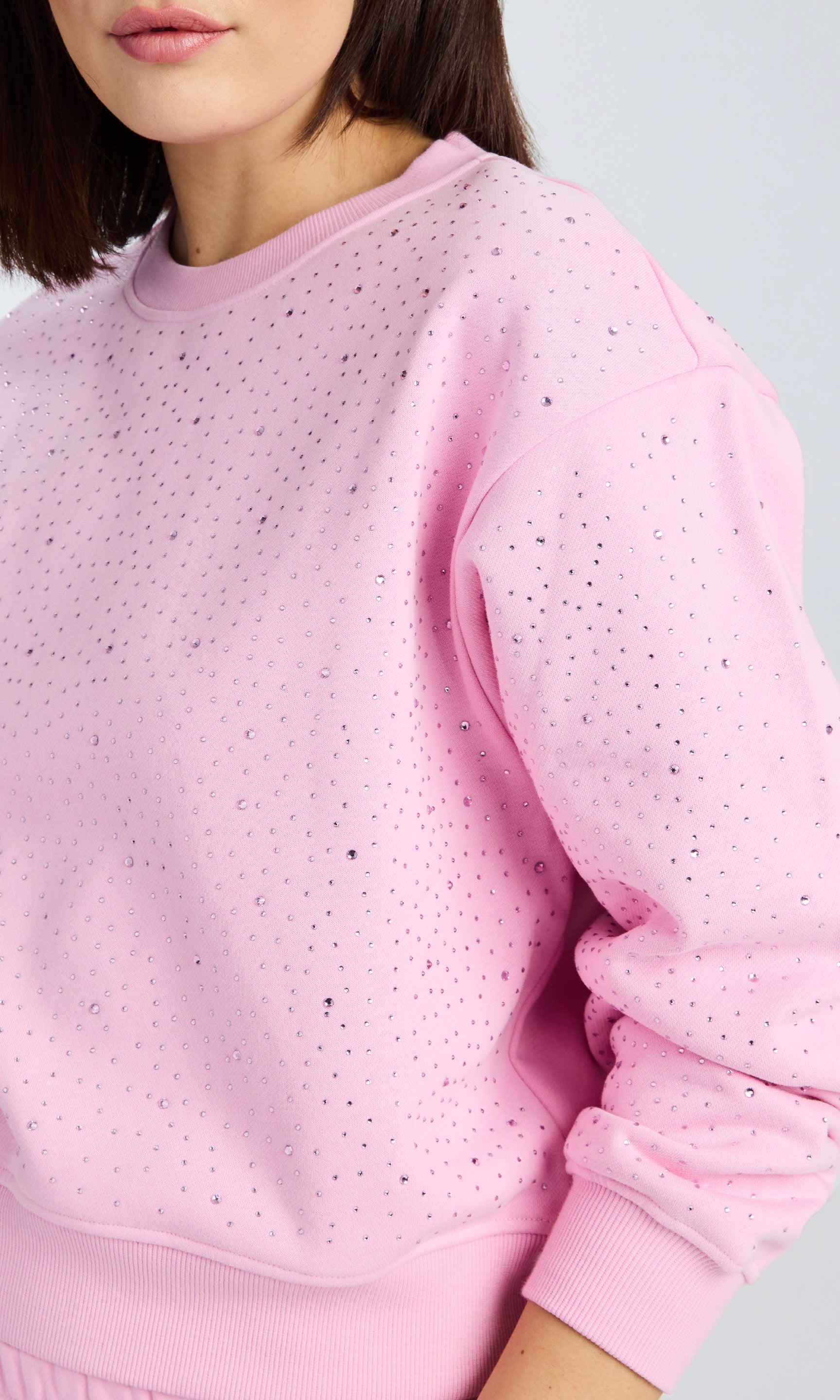 Close up detailed image of a crystal embellished sweatshirt