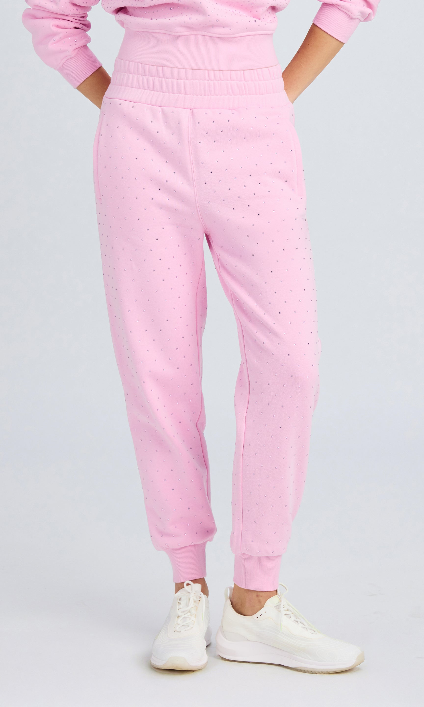 Front view of light pink sweatpants with all over crystal detail