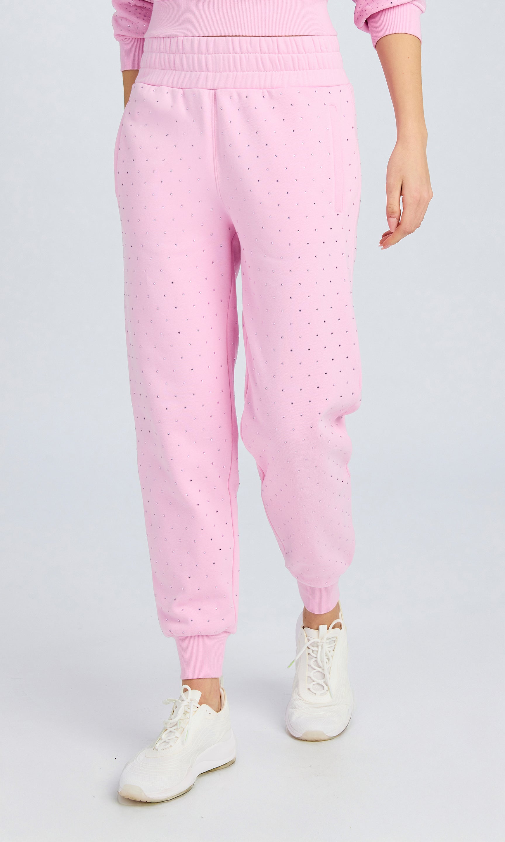 Front view of light pink sweatpants with crystal embellishments