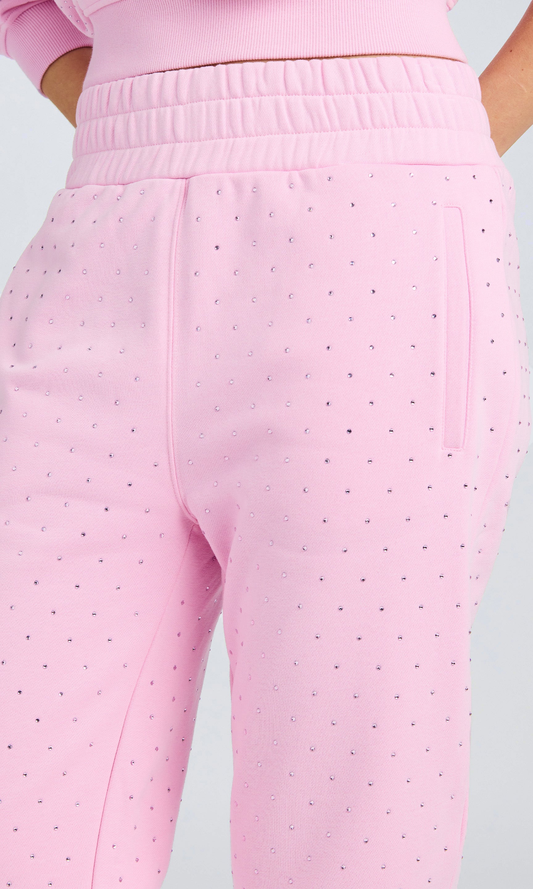 Close up detail of light pink sweatpants with all over crystal detail