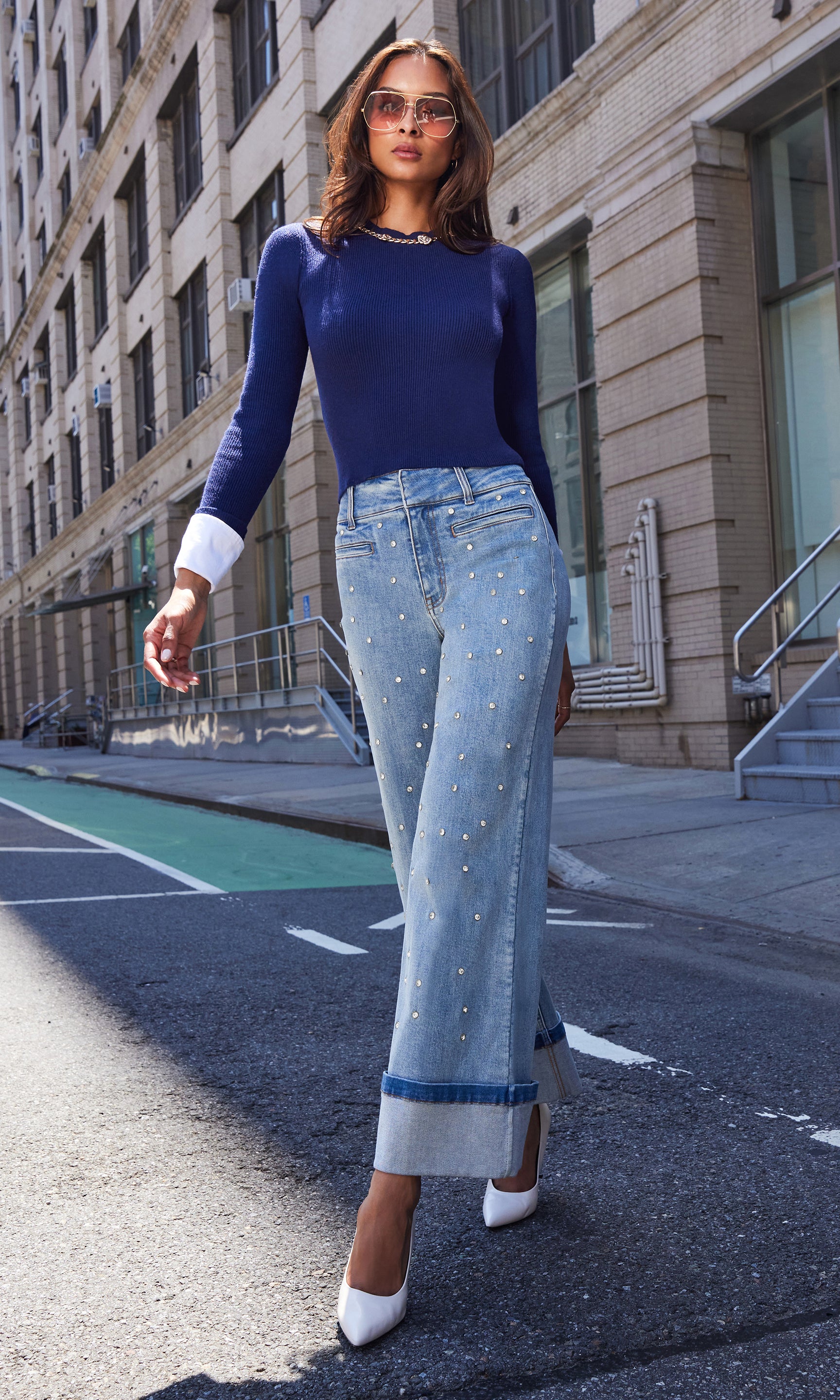 Full body front view of the Leiber Rib Sweater With Poplin Cuff styled with relaxed-fit distressed jeans outdoors.