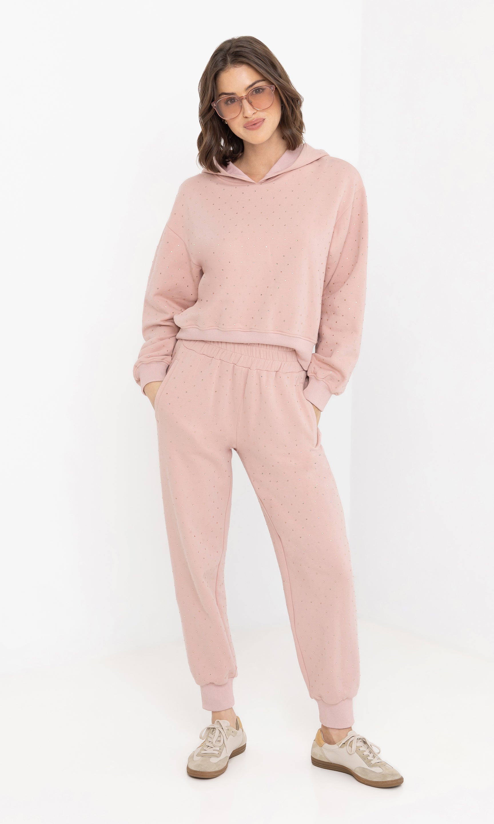 Full body front view of the model in the renae crystal hoodie styled with sweatpants.