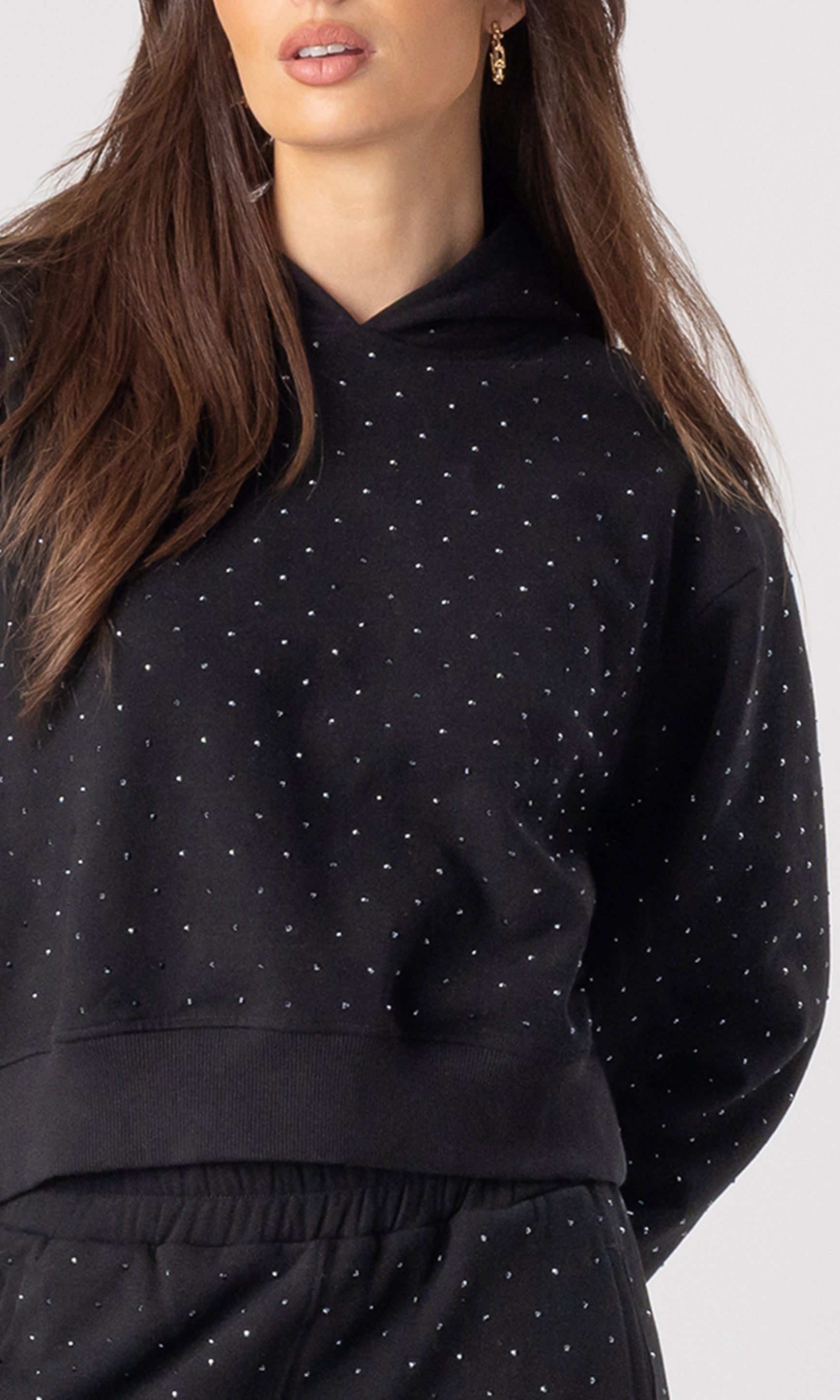 Black crystal hoodie worn by a person on a white background