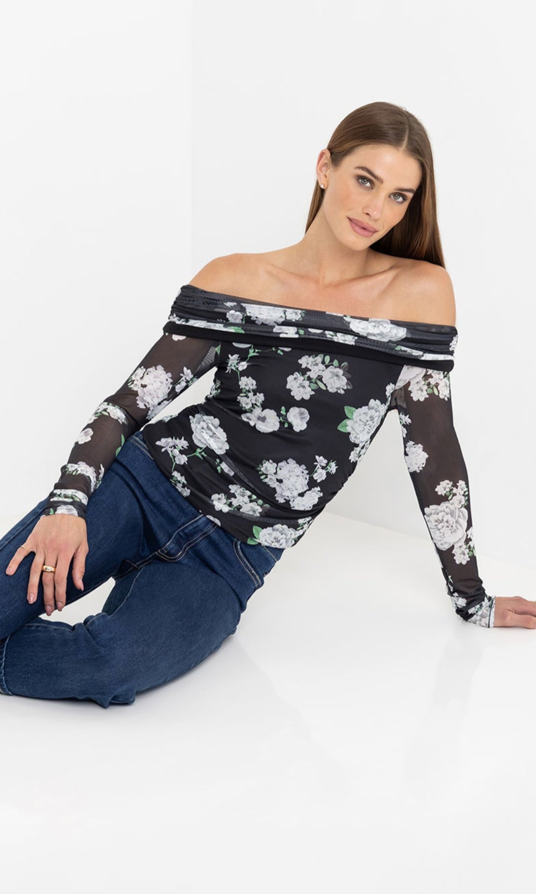 Seated front view of the model wearing the romeo floral mesh top.