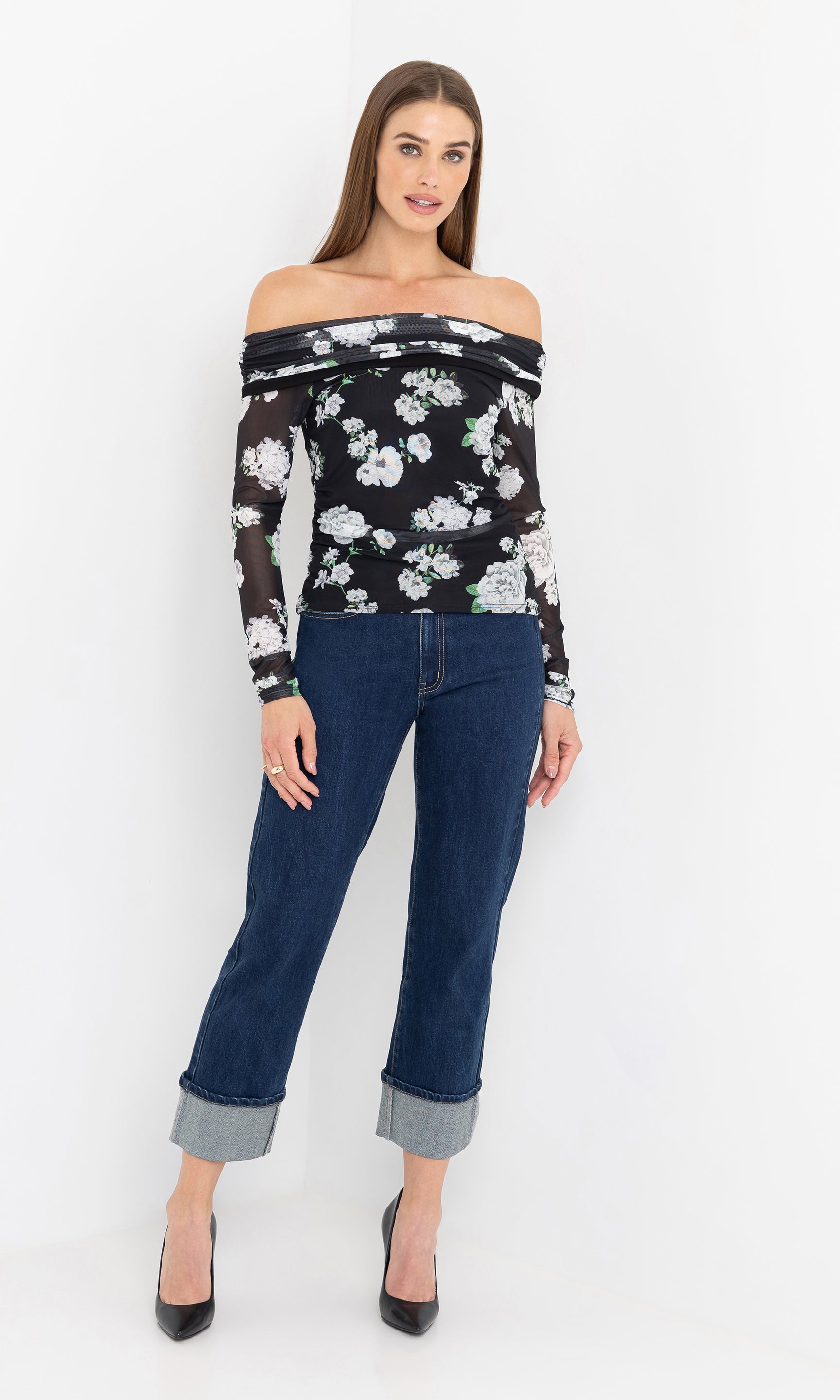 Full body front view of the model in the romeo floral mesh top styled with jeans.