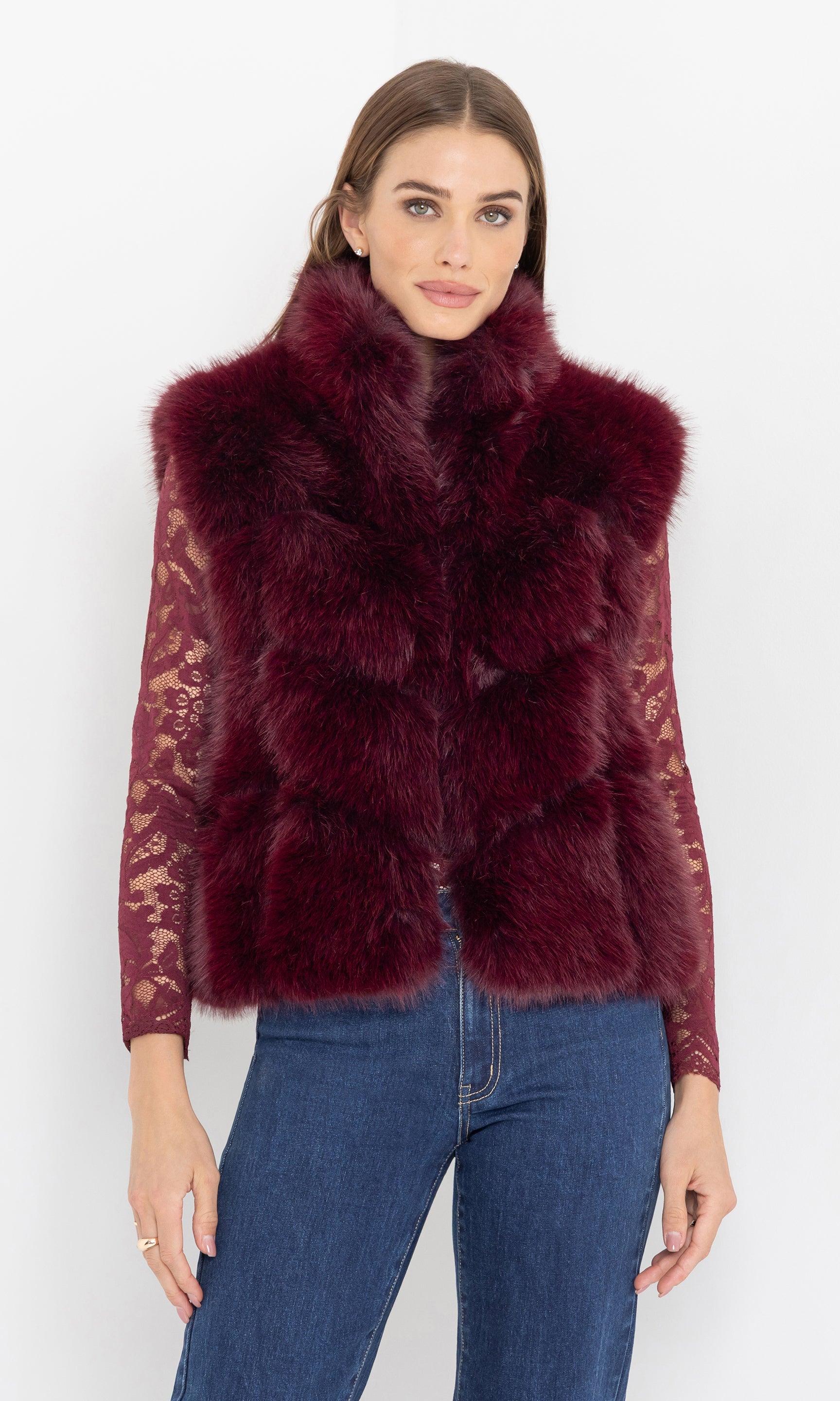 Front view of the rosario faux fur vest paired with jeans.