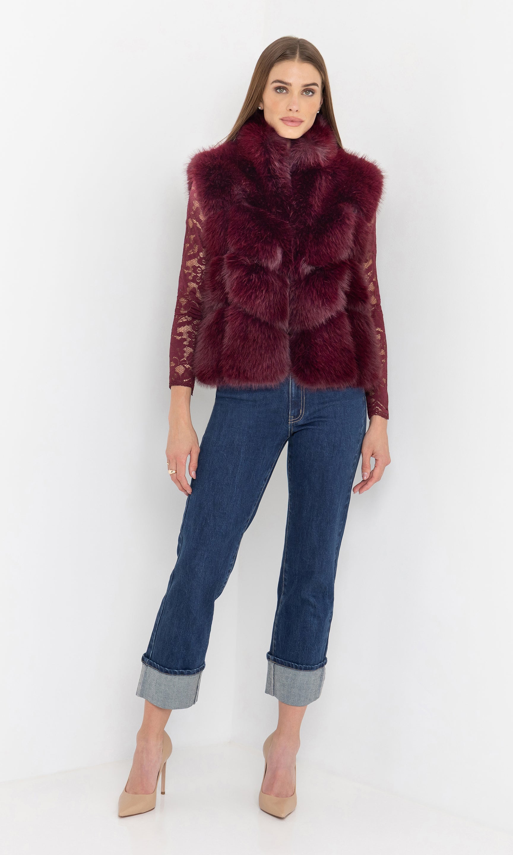 Full body front view of the rosario faux fur vest paired with jeans.