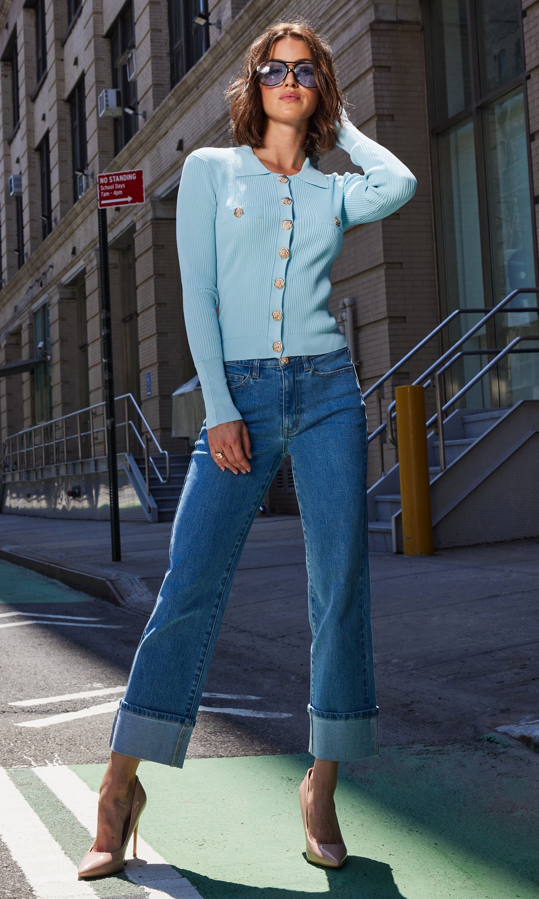 Front view of the Carter Rib Cardigan in light blue, styled casually with blue jeans, photographed in an urban street location.