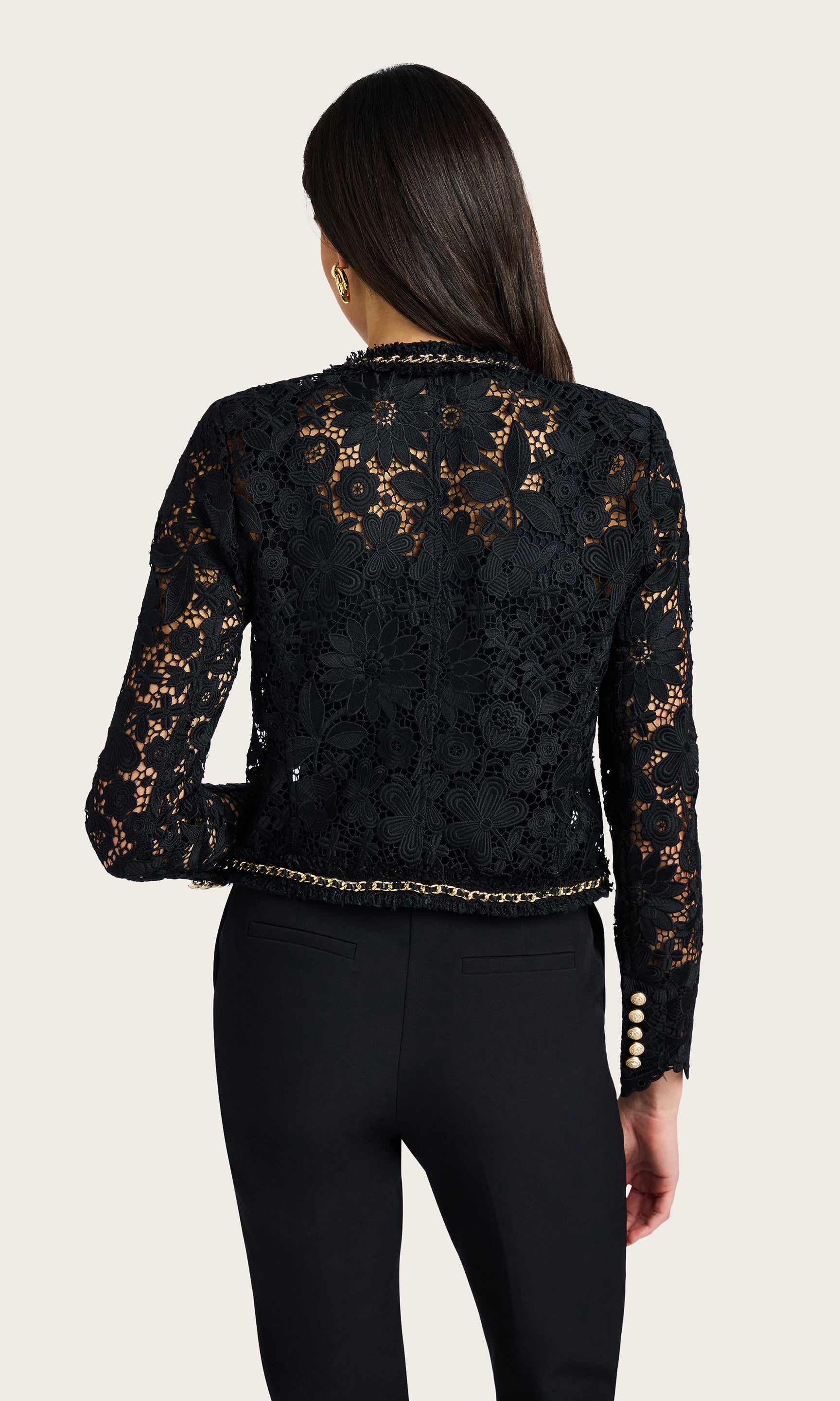 Back-facing view highlighting the lace paneling and cropped fit of the jacket