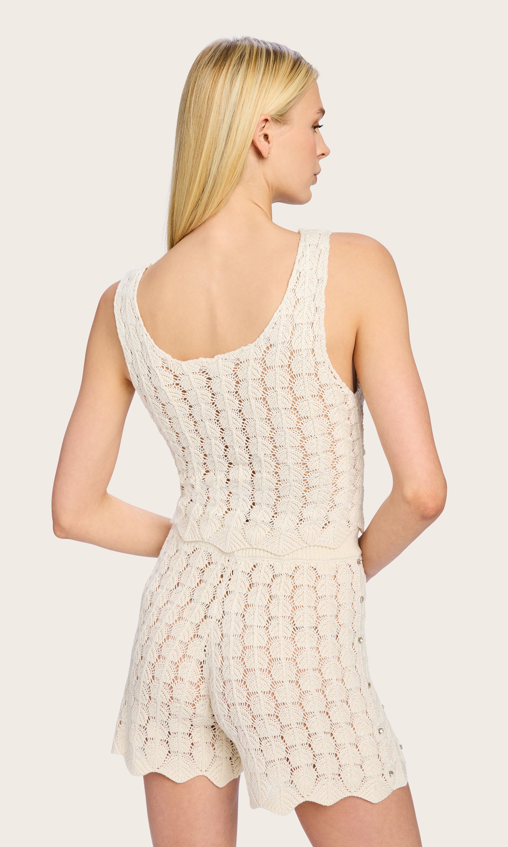 Rear view of the model in the Sol Crystal Pointelle Knit Tank, drawing attention to the racerback cut and detailed knit pattern.
