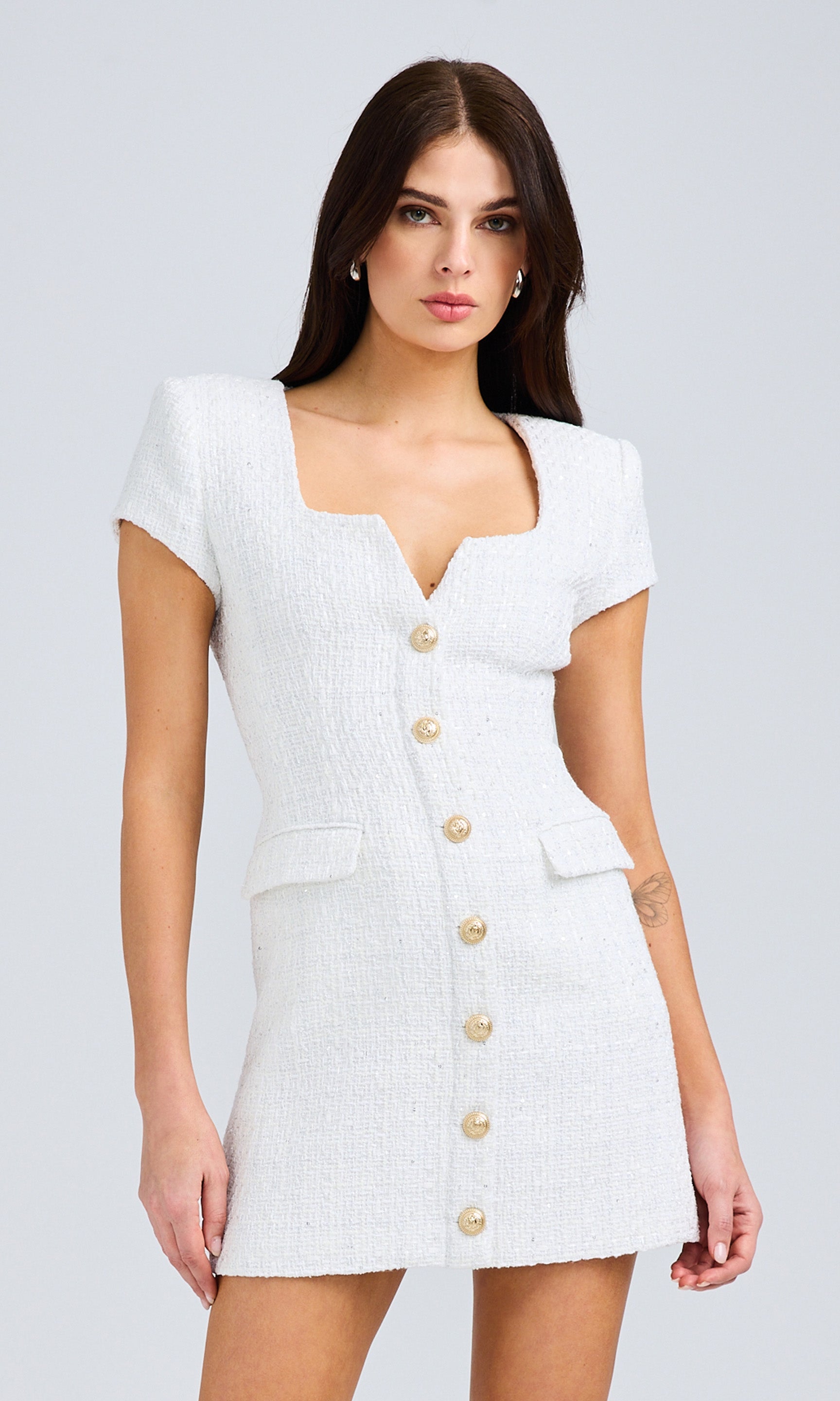 Mid-length front view focusing on the dress’s button details and structured silhouette.