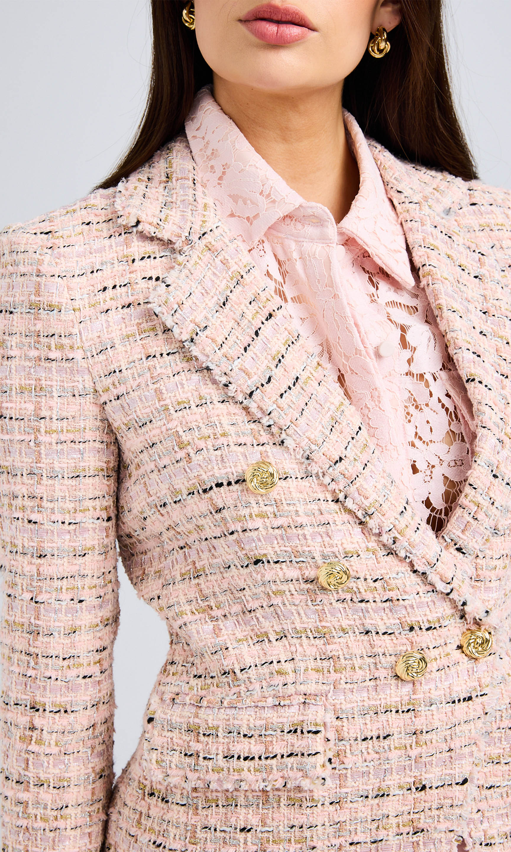 Close-up highlighting the intricate texture of the tweed fabric and polished gold buttons