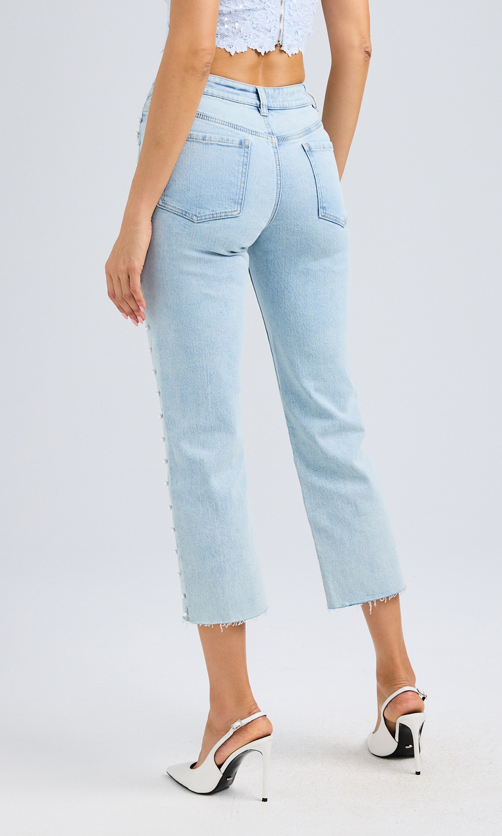 Rear view of the jeans, showcasing the structured back pockets and flattering fit.