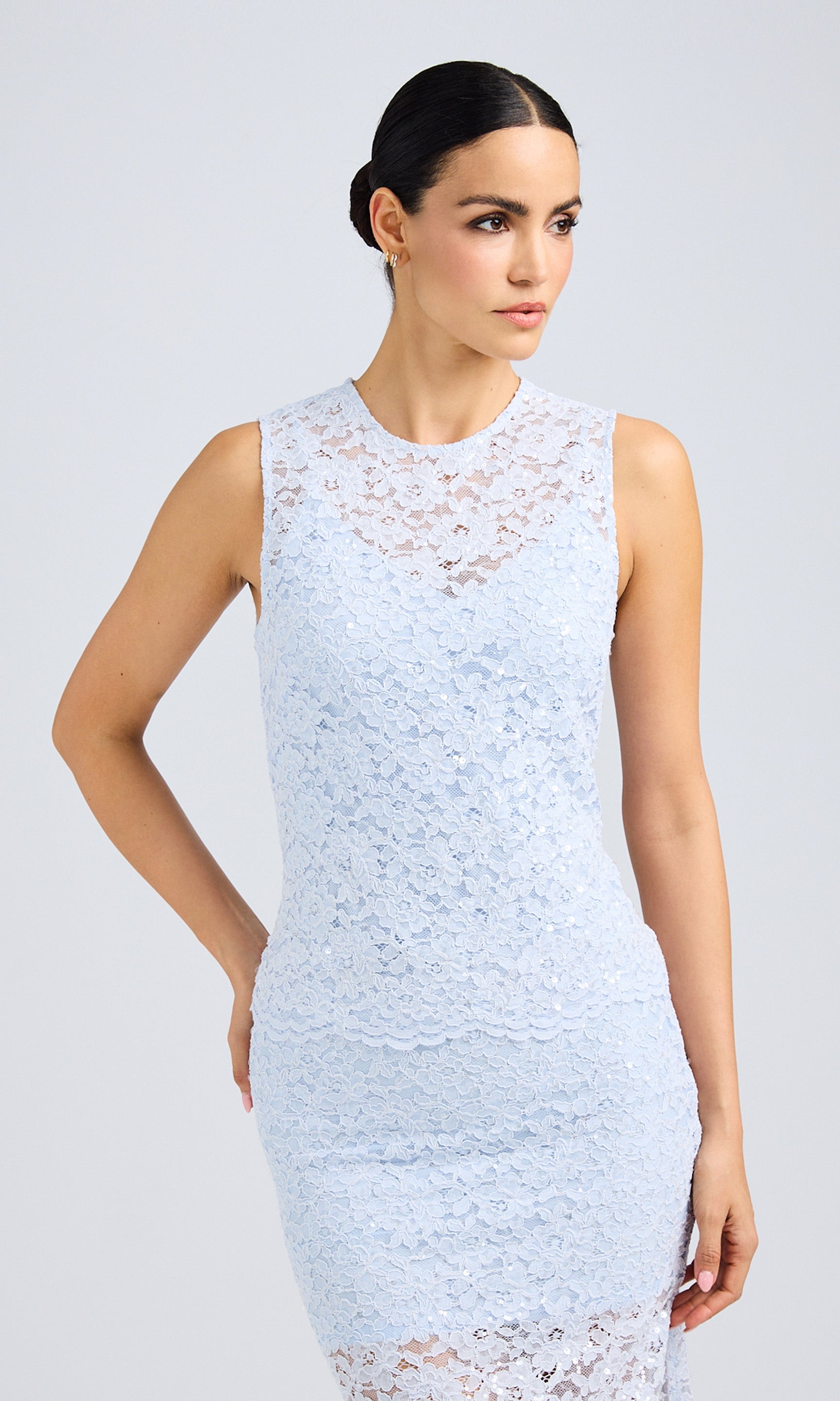 Front view of the model in the lace top, showcasing its sleeveless design and delicate texture.