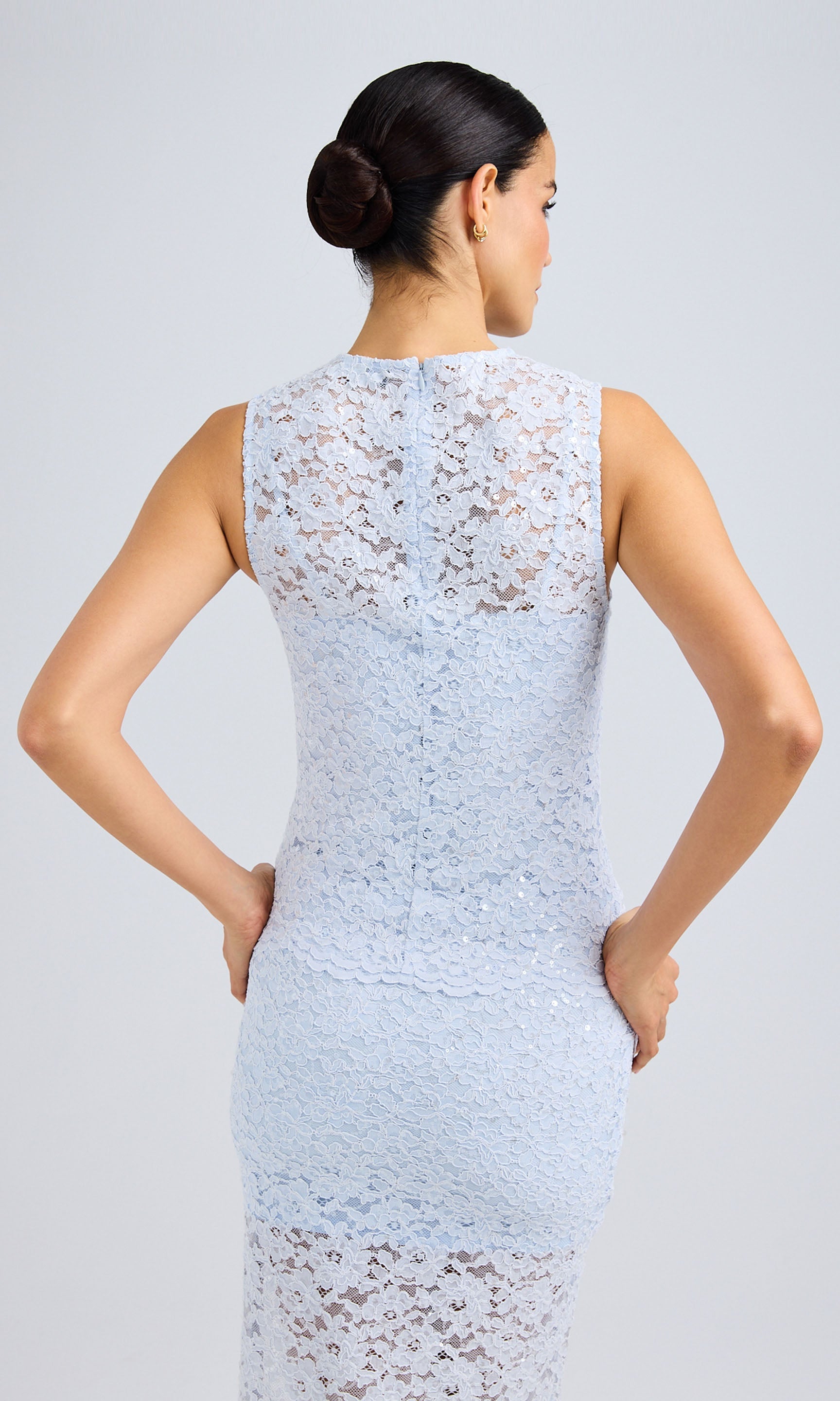 Rear view displaying the lace overlay and fitted silhouette.