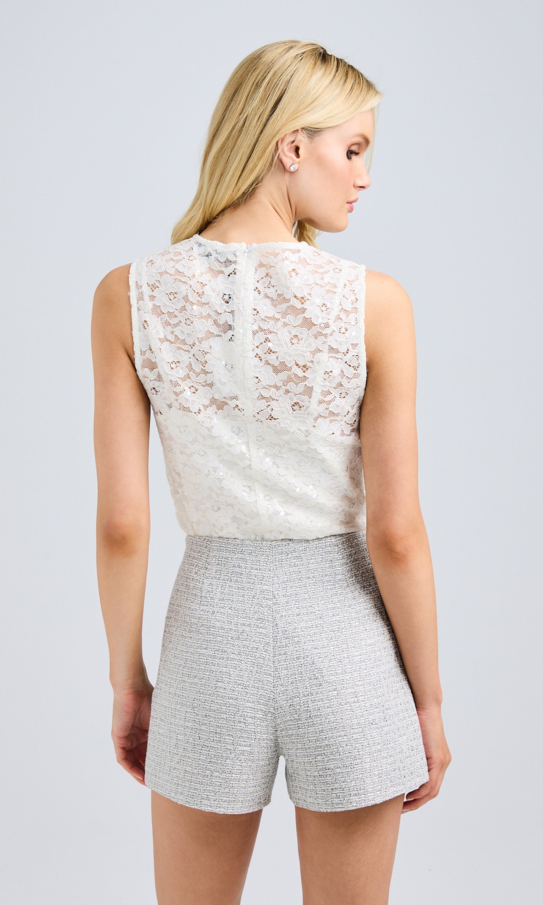 Rear view showing the sheer lace back and fitted design.