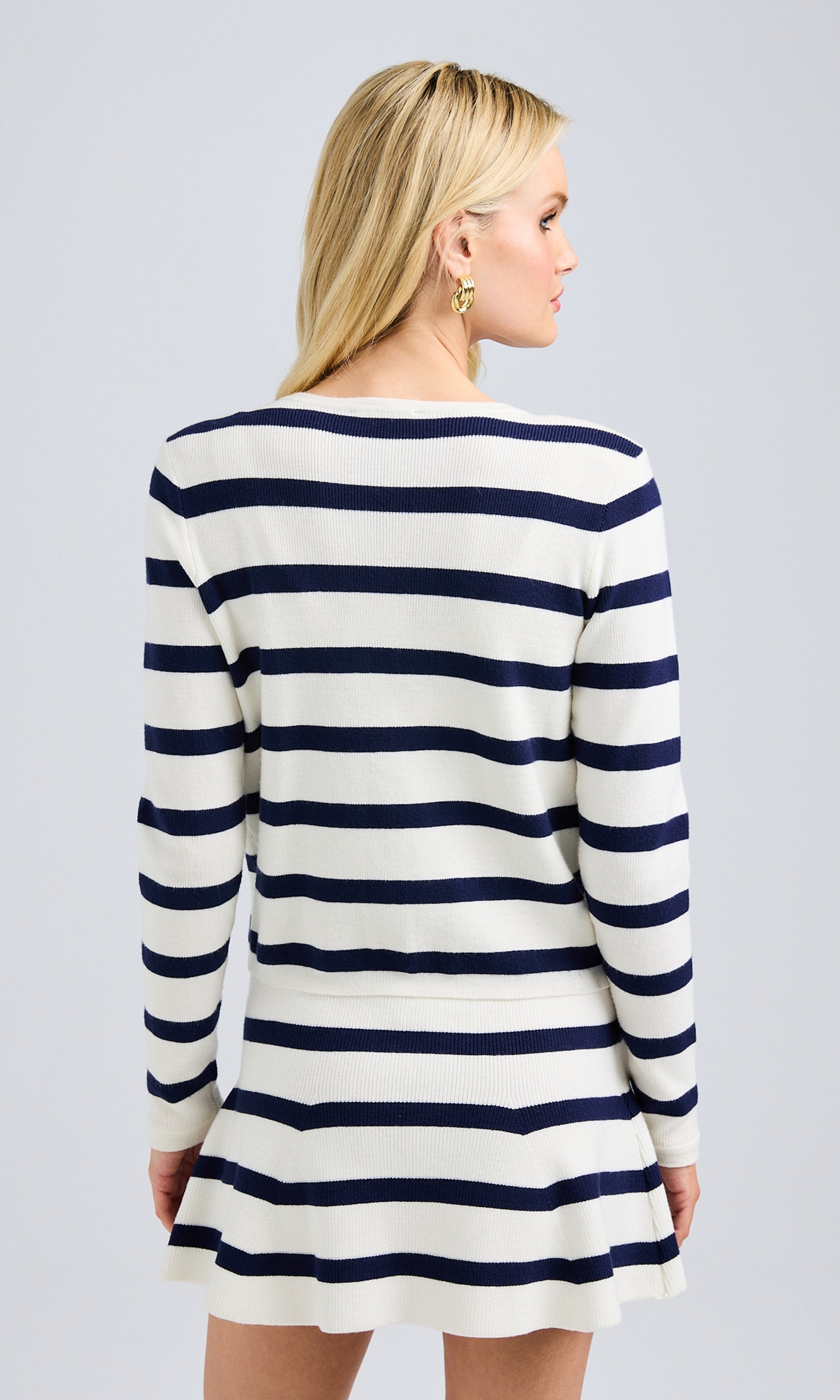 Rear view of the striped knit cardigan, displaying the bold stripe pattern and long sleeves.