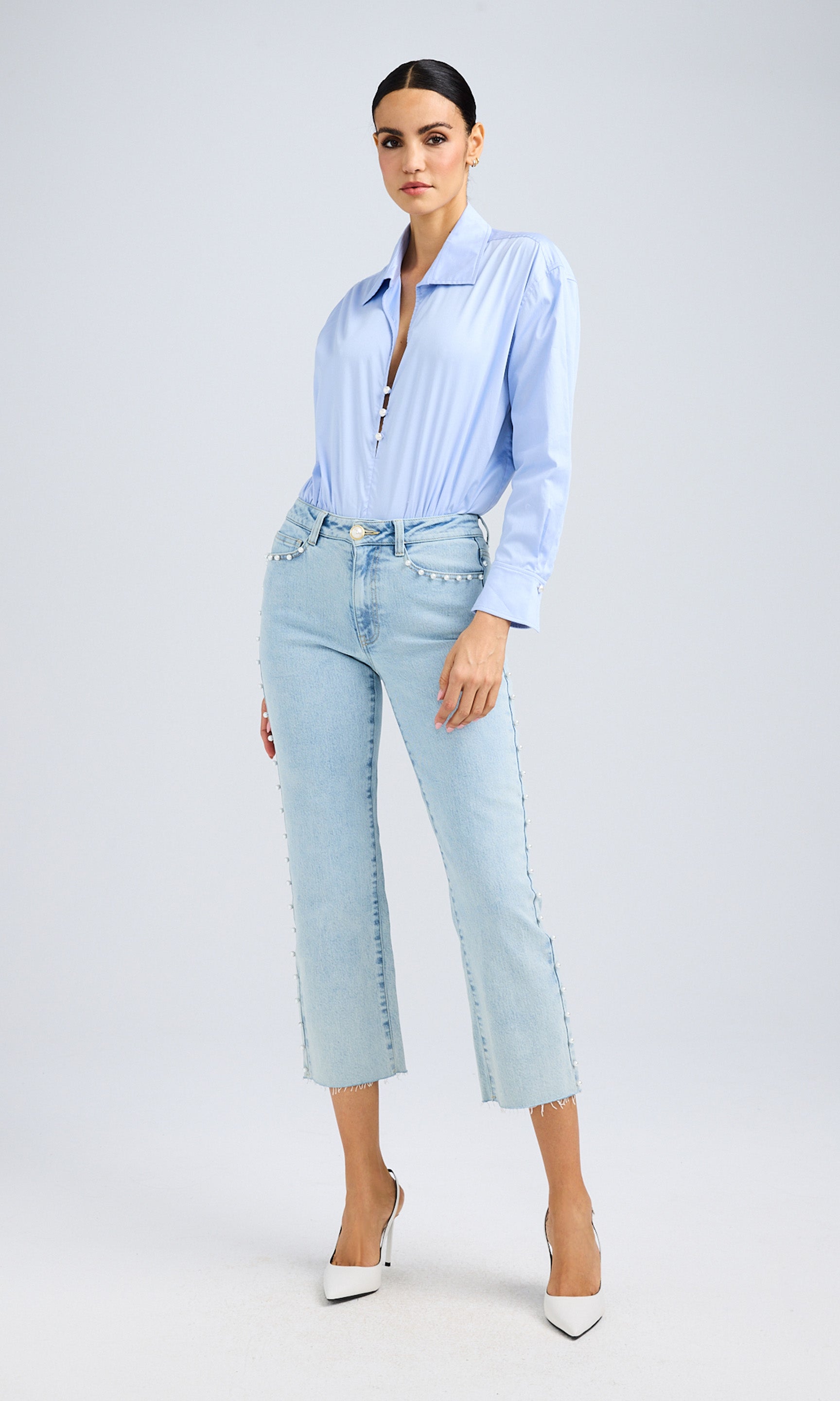 Full-body shot of the model in the light blue shirt and jeans, displaying the outfit’s effortless styling.