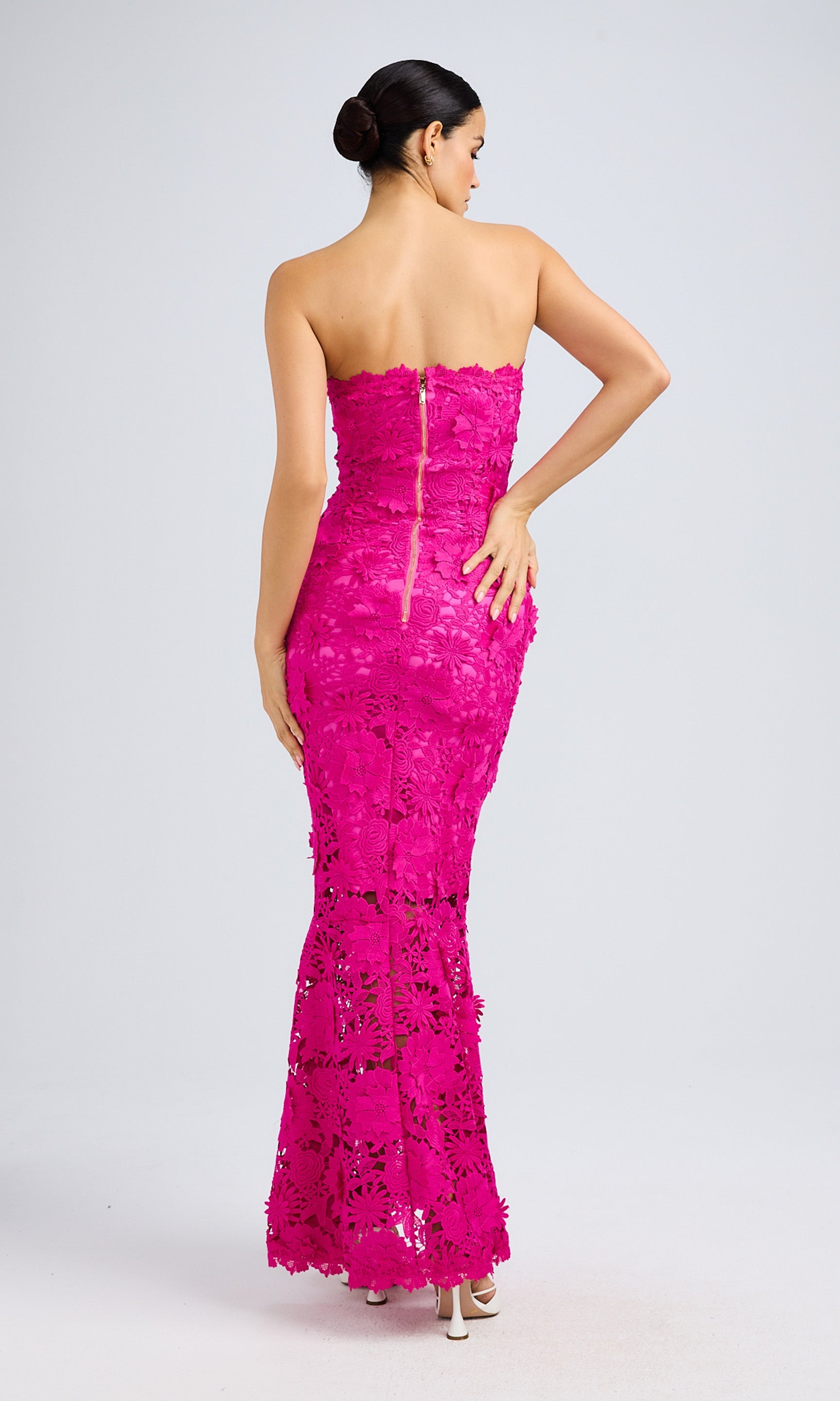 Rear view highlighting the elegant lace details and structured fit.
