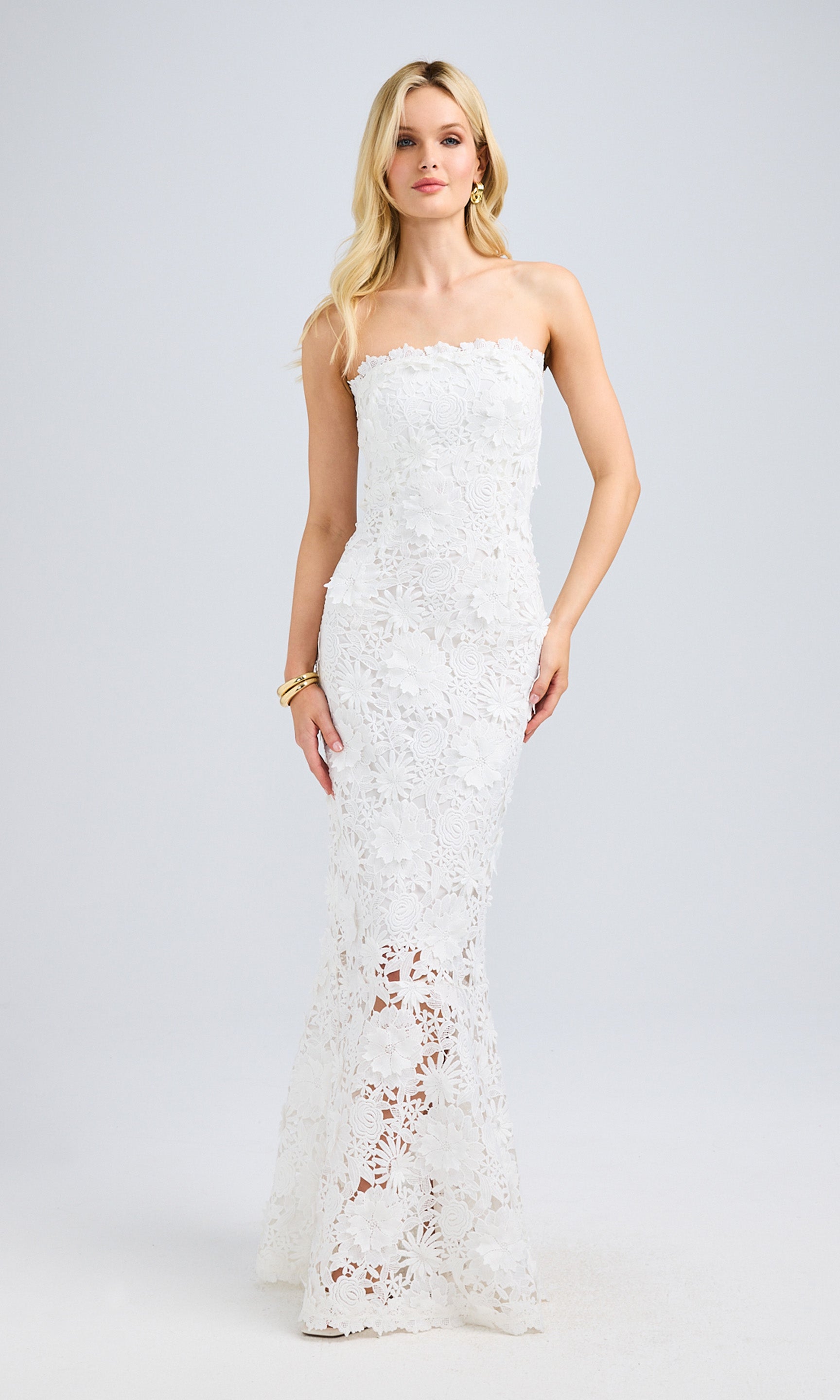 Full-body front view of the model in the lace gown, showcasing its figure-hugging silhouette and intricate floral lace details.