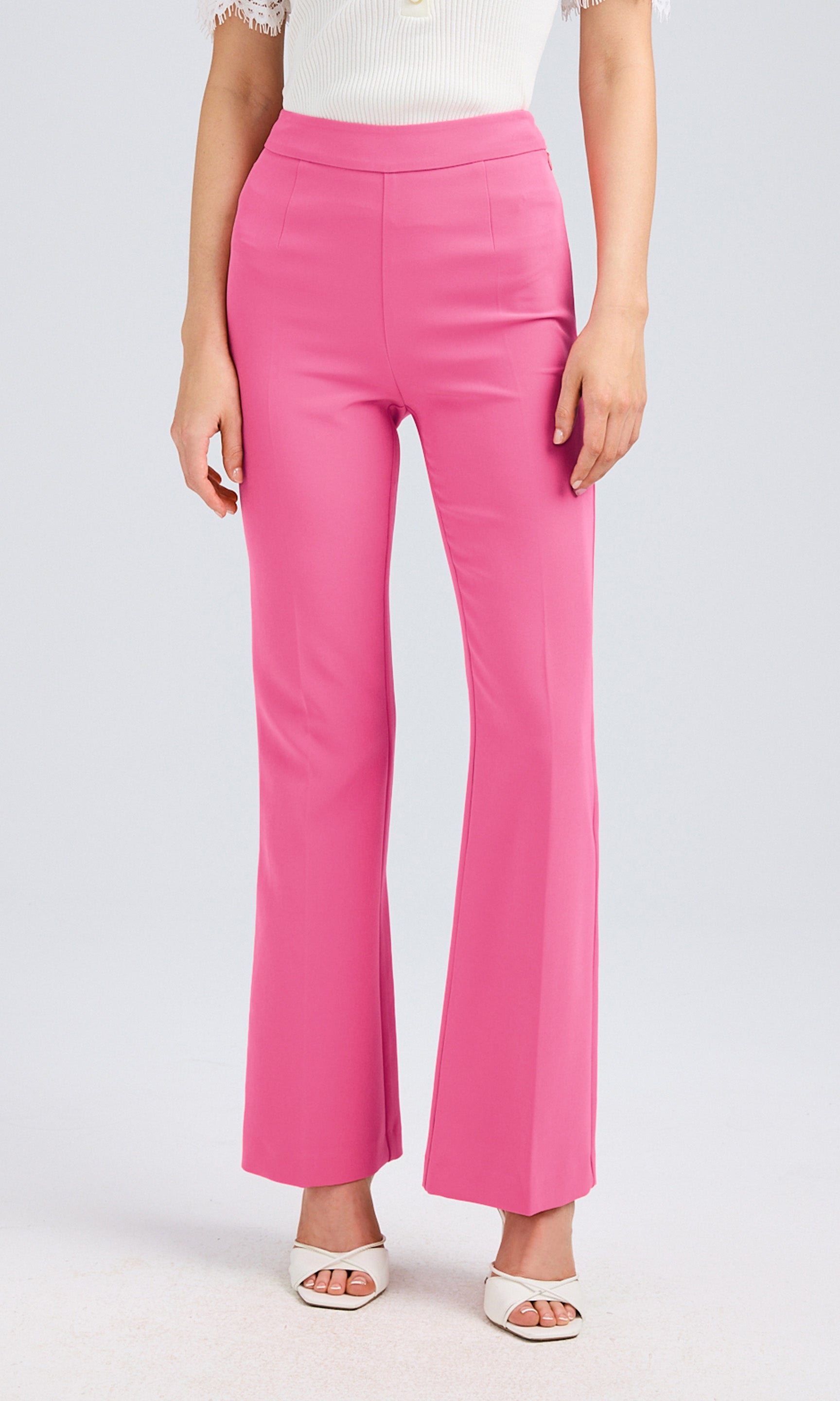 Front view highlighting the high-waisted fit and tailored silhouette of the pink crepe pants